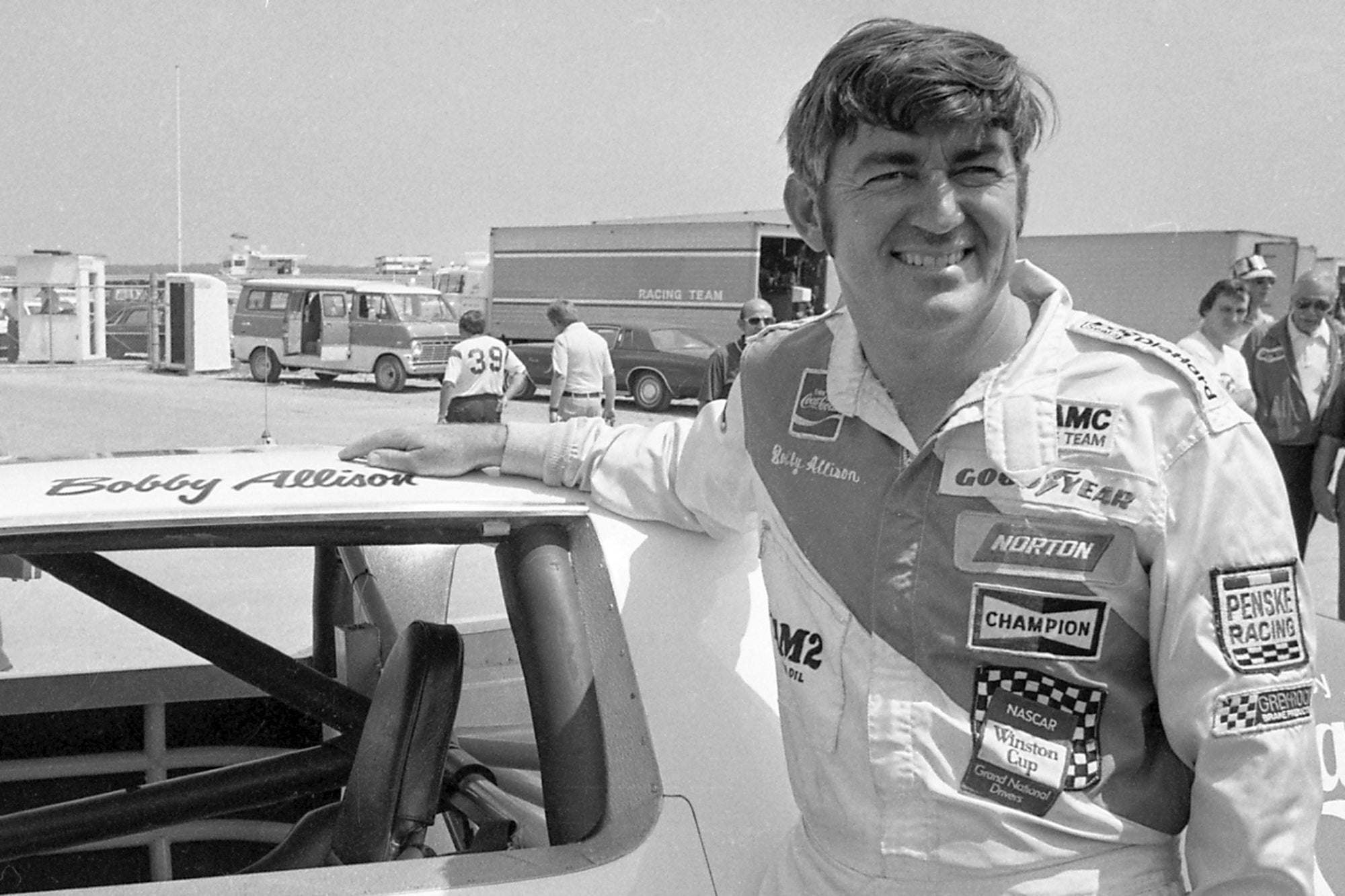 Bobby Allison stands beside his car and talks with the press after winning the pole position during qualifying for the 500 mile grand national stock car race at Pocono Raceway, August 2, 1975, in Long Pond, Pennsylvania