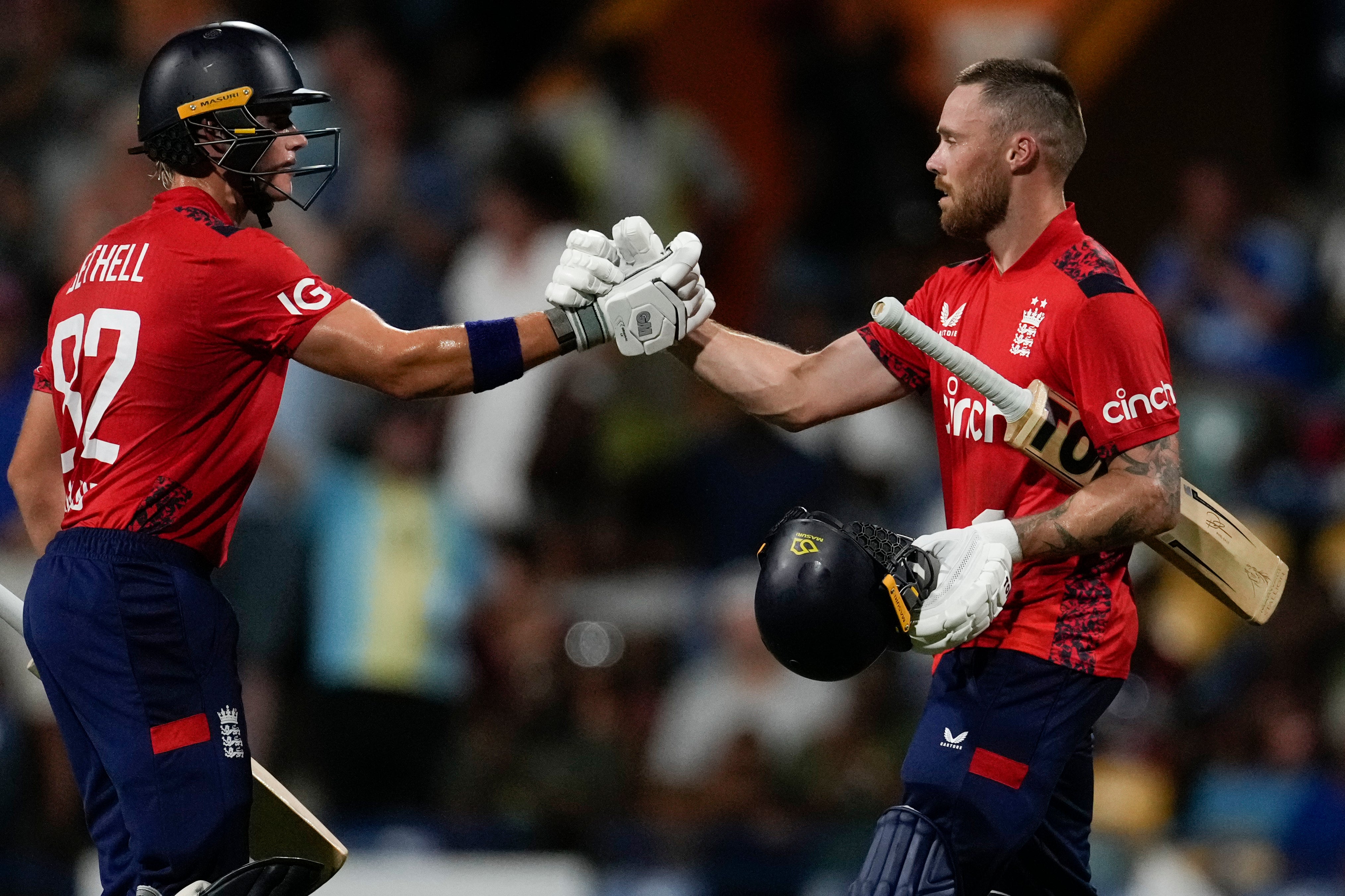 England’s Phil Salt, right, celebrates with Jacob Bethell after scoring his century (Ricardo Mazalan/AP)