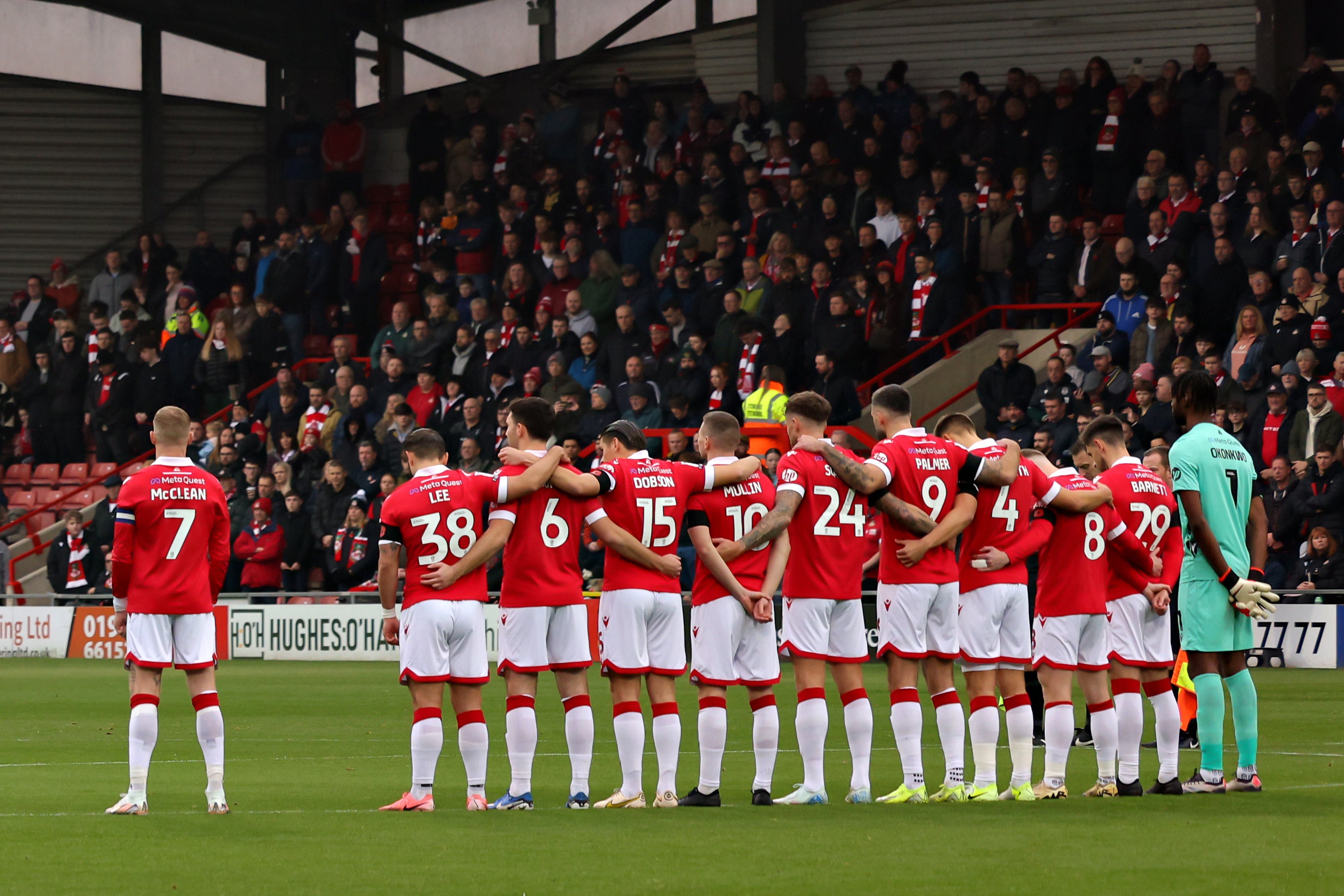 Wrexham’s James McClean stood away from his team-mates during the minute’s silence