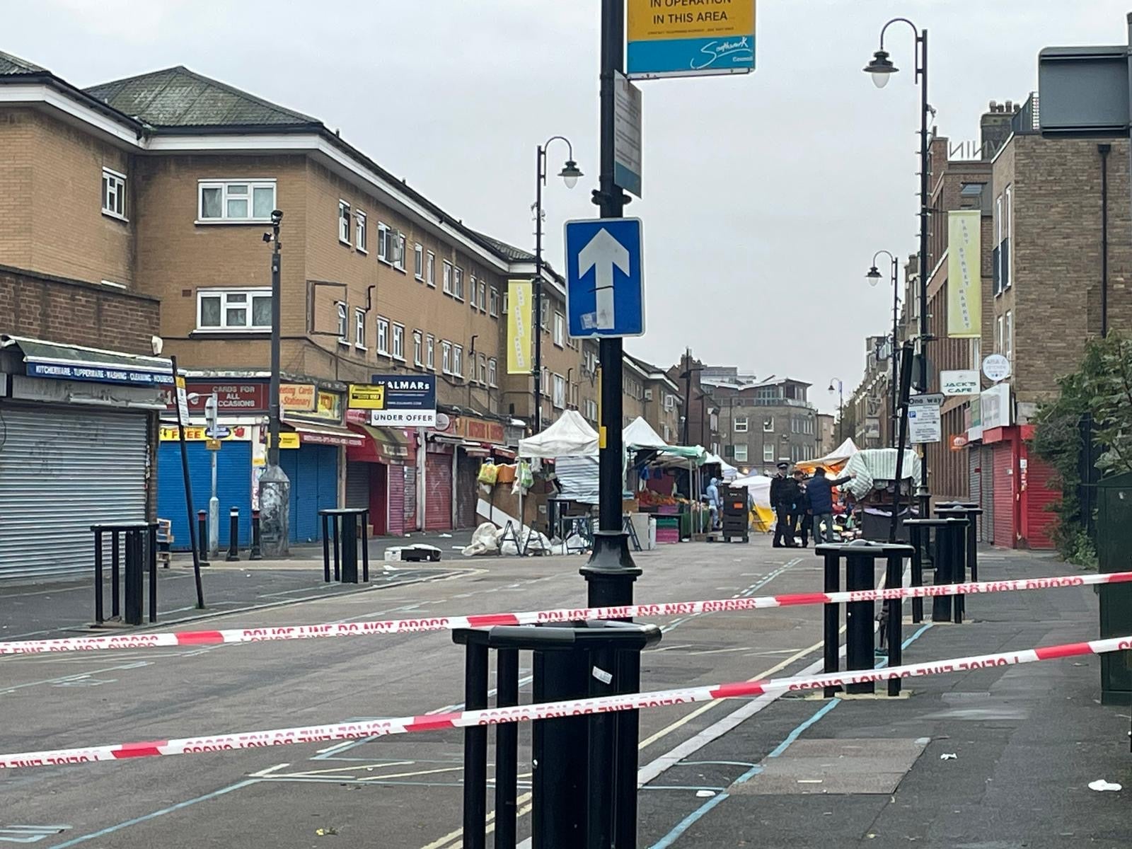 Police forensics at the scene of a triple stabbing at a busy market in East Street, south London