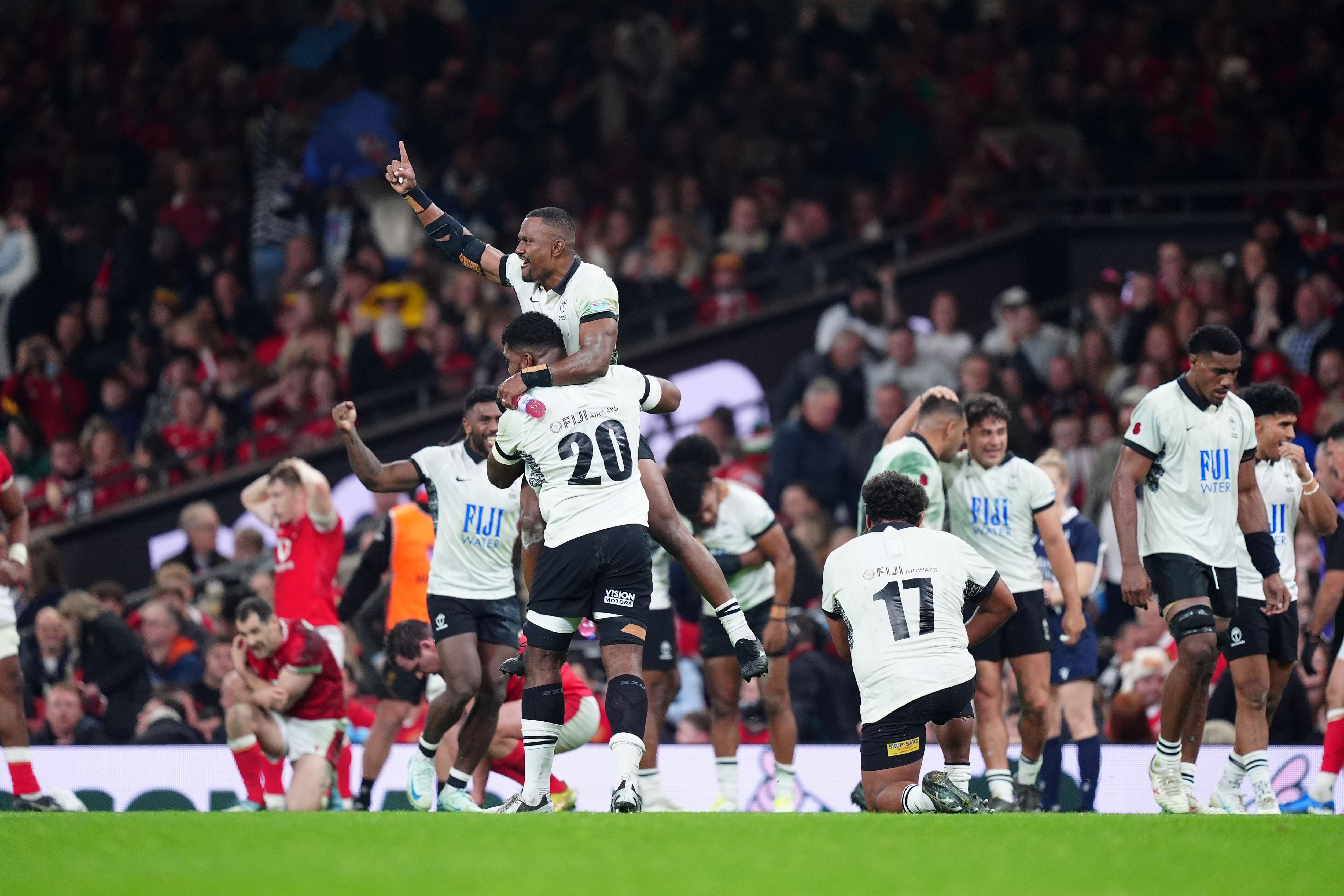 Fiji players celebrate their victory at the Principality Stadium