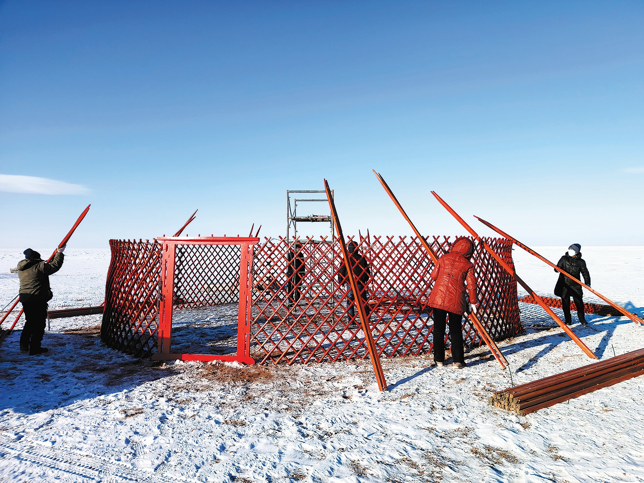 Workers build the framework of a yurt