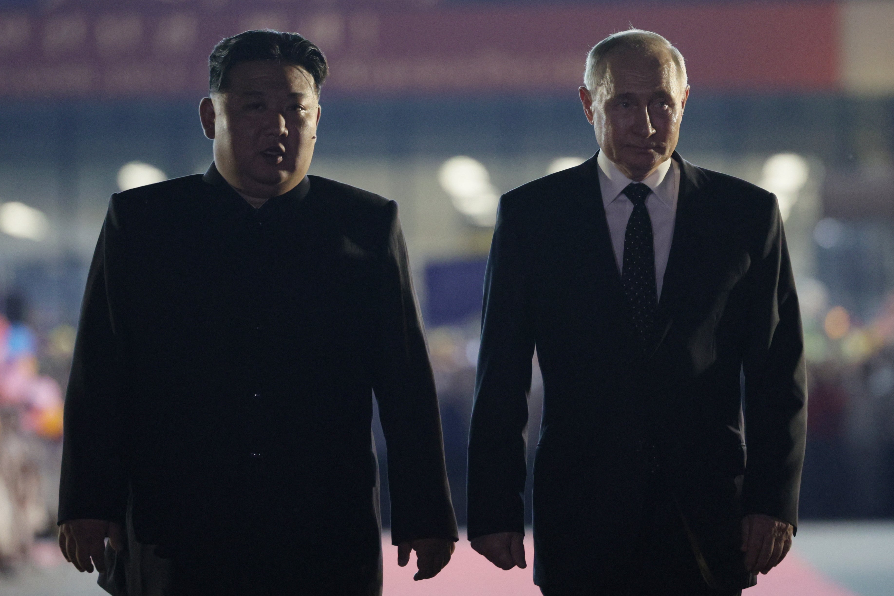 In this pool photograph distributed by the Russian state agency Sputnik, Russian President Vladimir Putin (R) and North Korean leader Kim Jong Un walk during a farewell ceremony upon Putin's departure at the Sunan International Airport in Pyongyang on June 19, 2024. Putin enjoyed a red carpet welcome, a military ceremony and an embrace from North Korea's Kim Jong Un during a state visit to Pyongyang where they both pledged to forge closer ties. (Photo by Vladimir Smirnov / POOL / AFP) / -- Editor's note : this image is distributed by the Russian state owned agency Sputnik