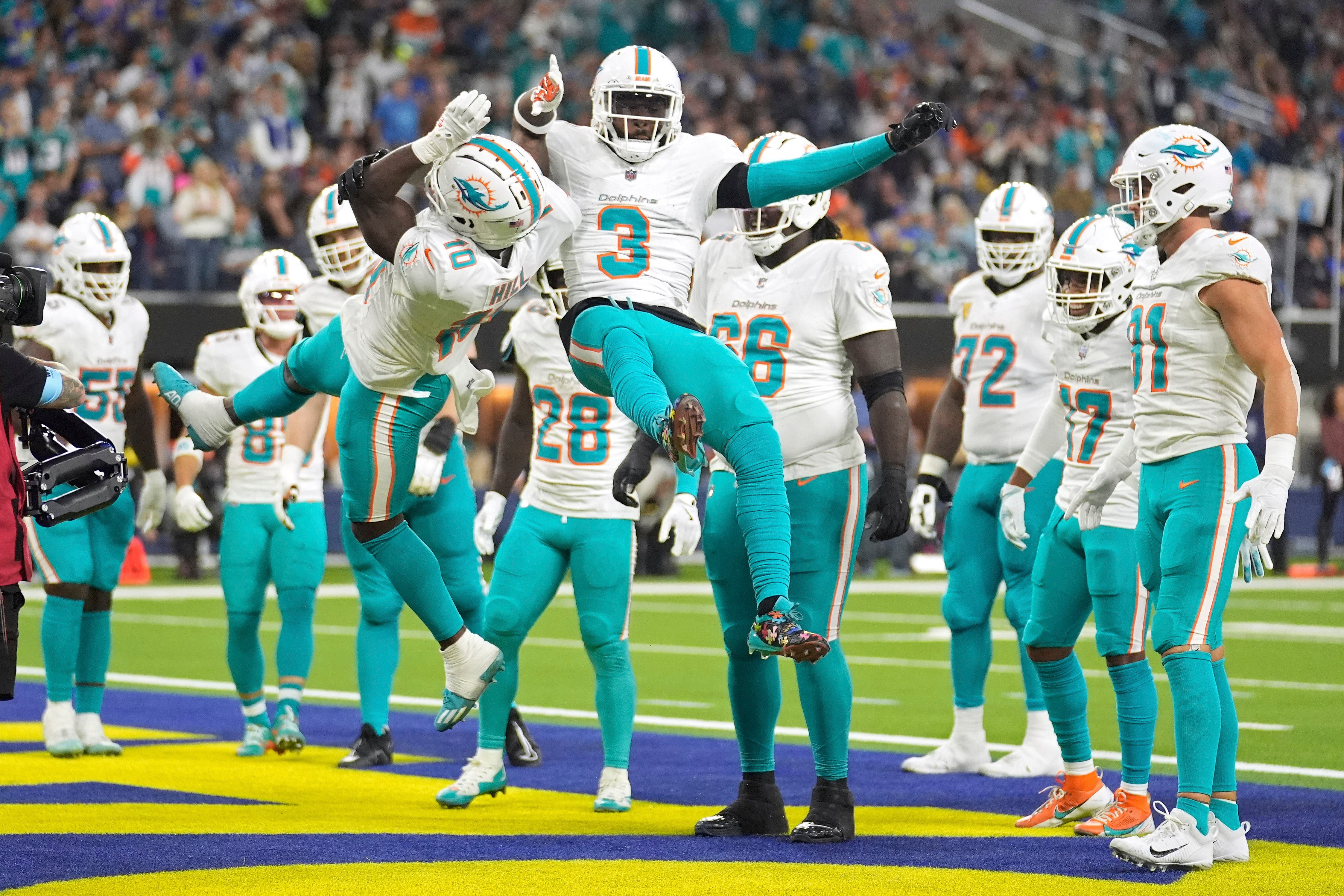 Miami Dolphins wide receiver Tyreek Hill, left, celebrates his touchdown with wide receiver Odell Beckham Jr (Marcio Jose Sanchez/AP)