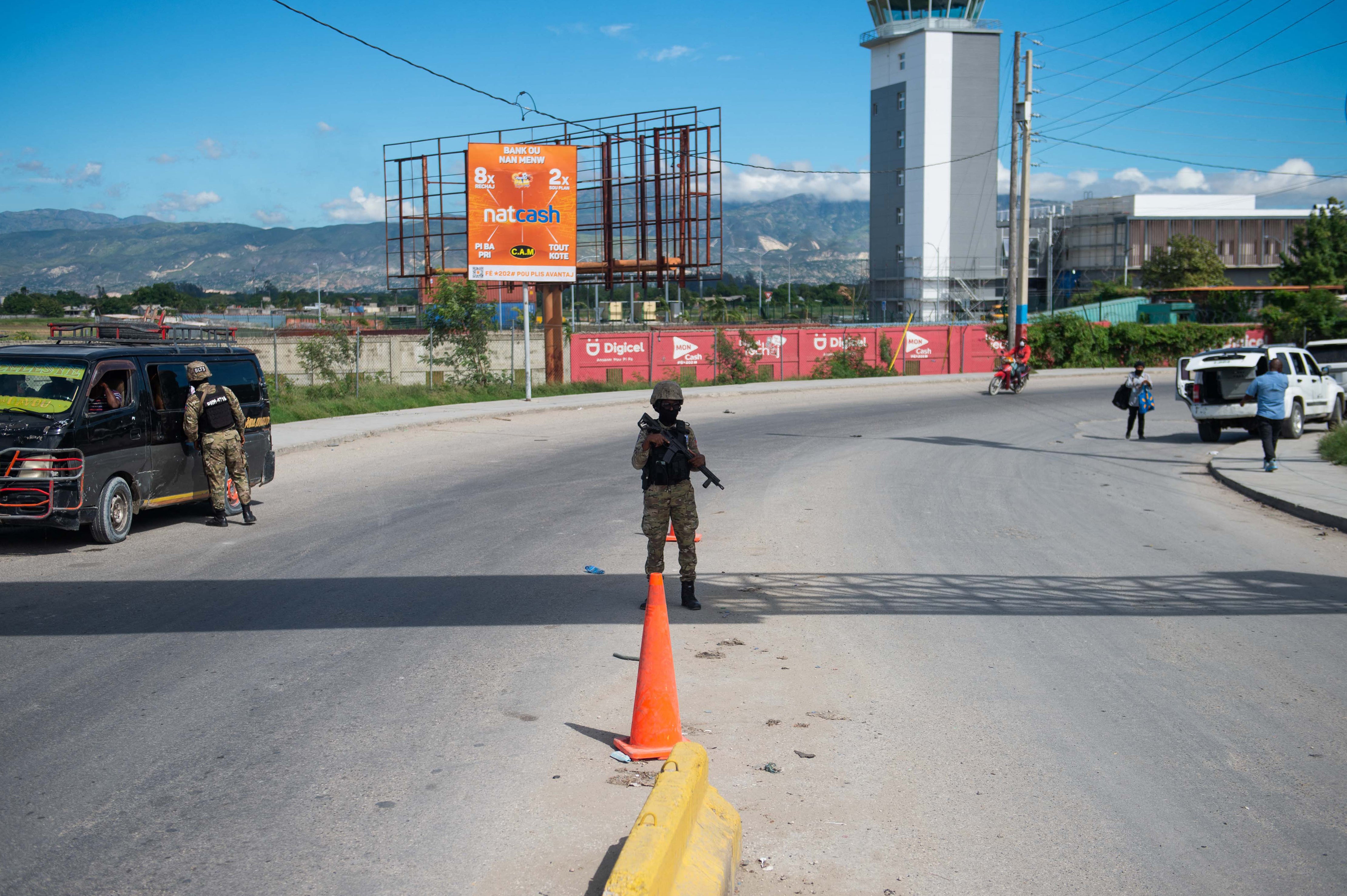 Police guard the Toussaint Louverture International Airport, which is now closed after gang gunfire struck a descending Spirit Airlines flight on Monday