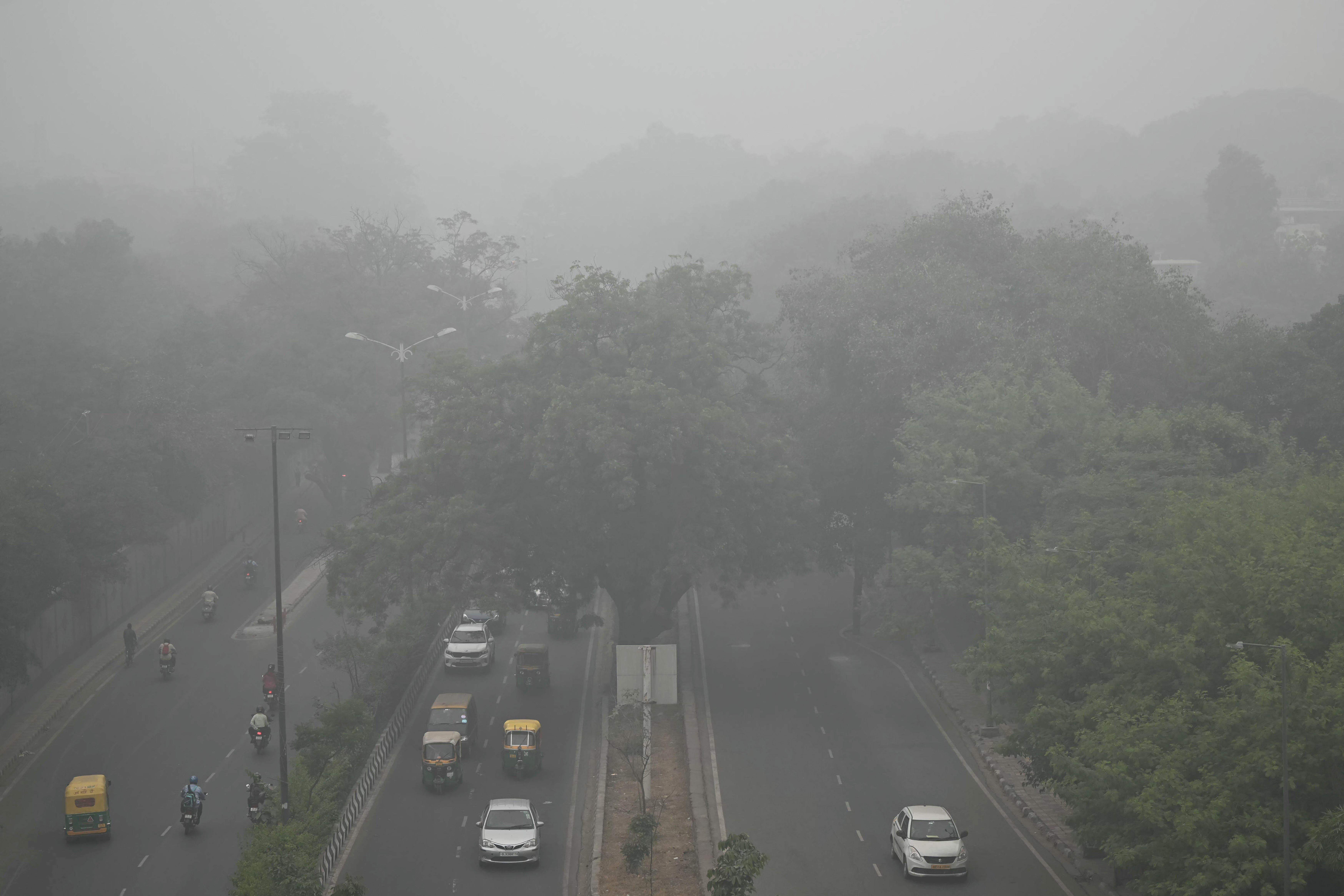 Commuters drive amid dense smog in New Delhi