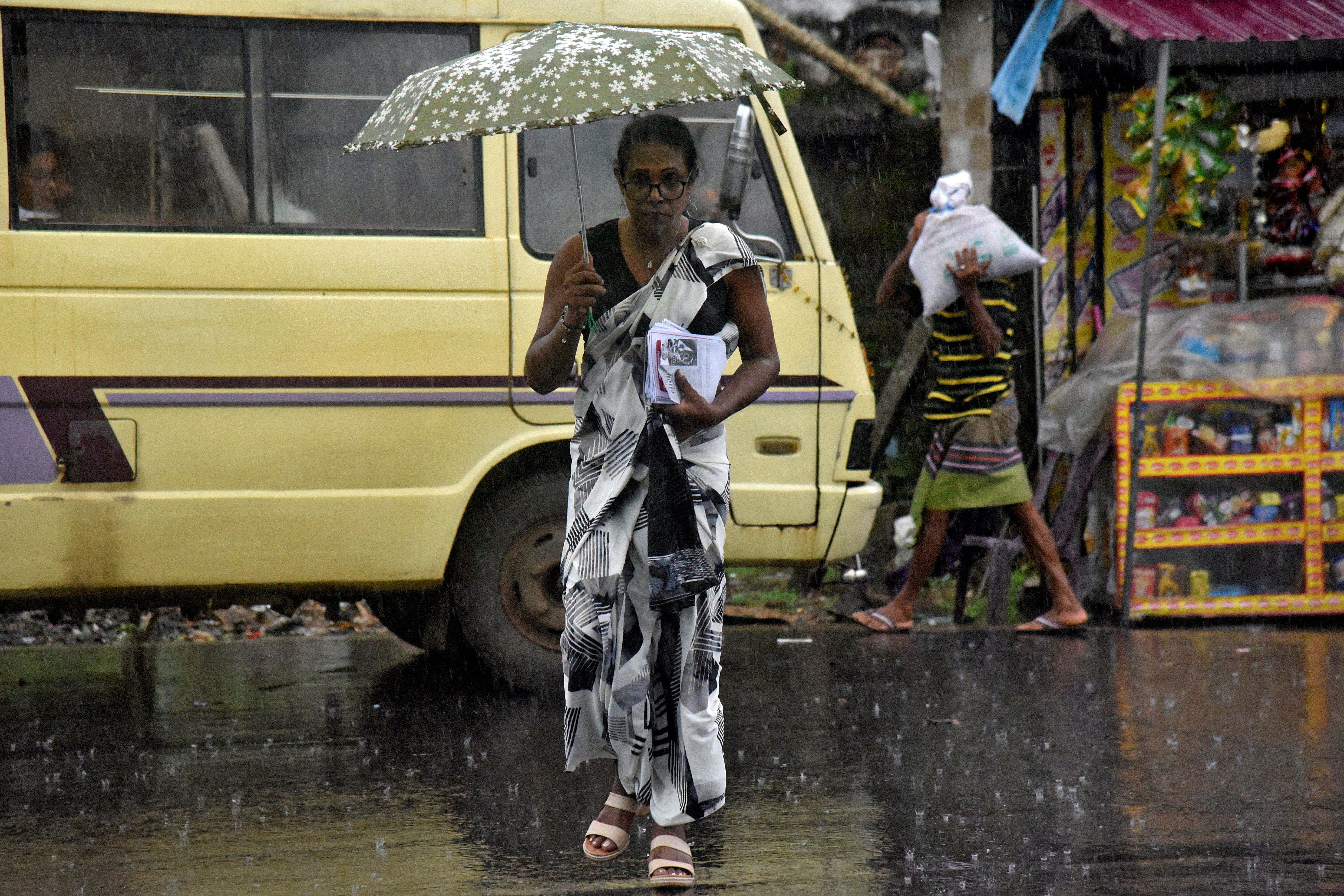 Chanu Nimesha carries pamphlets while campaigning in Warakapola, Sri Lanka, on 8 November 2024