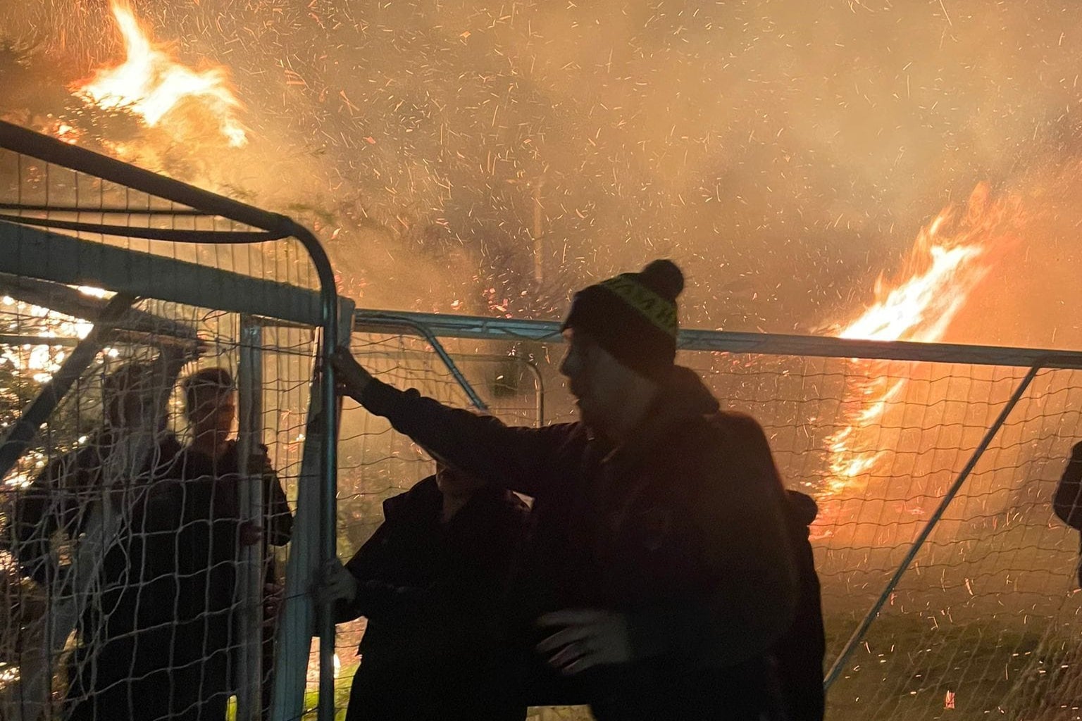 Brave parents move play equipment way from the inferno at Halisham Football Club