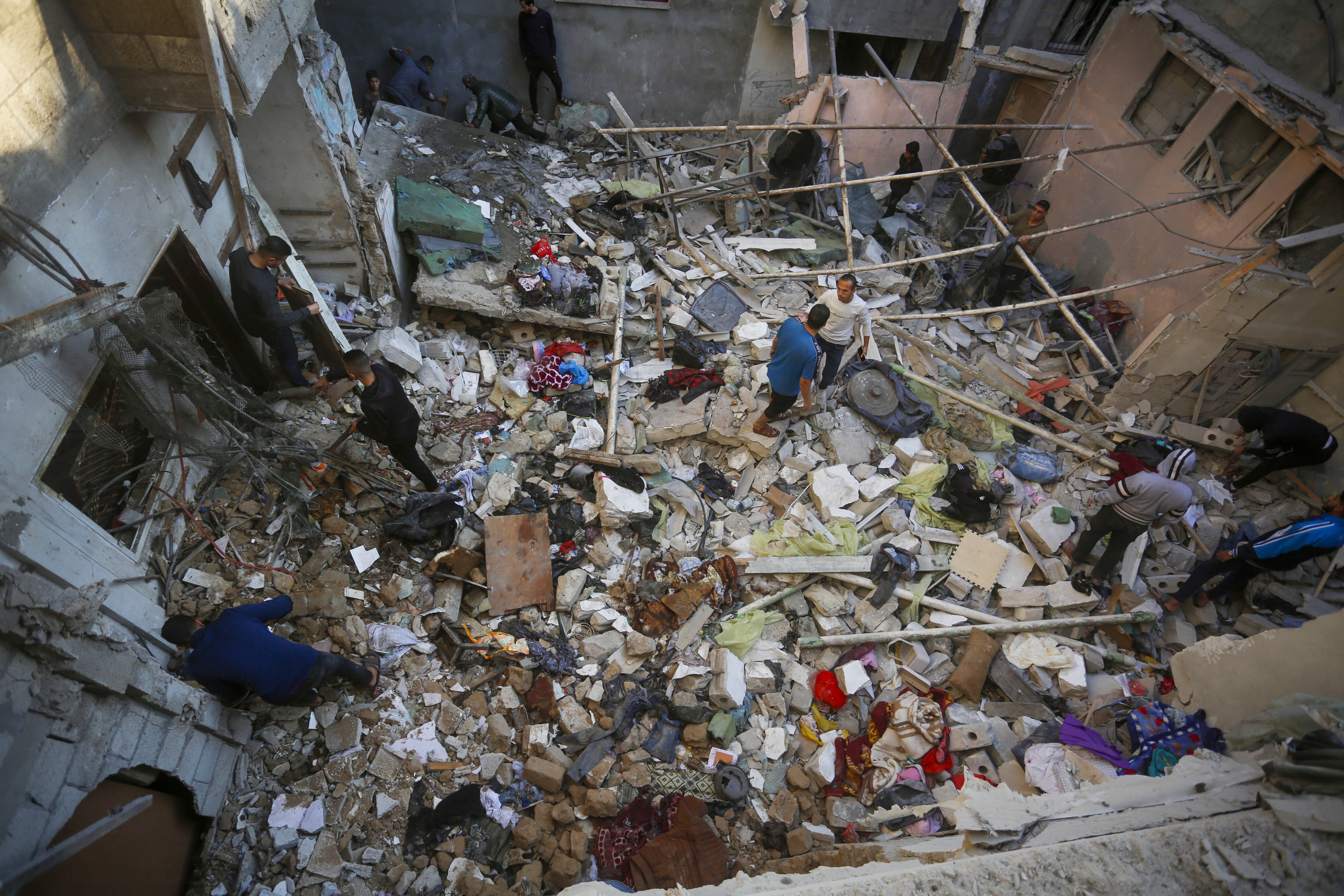 People inspect the scale of destruction after an Israeli attack in Nuseirat Refugee Camp in Gaza on 13 November 2024