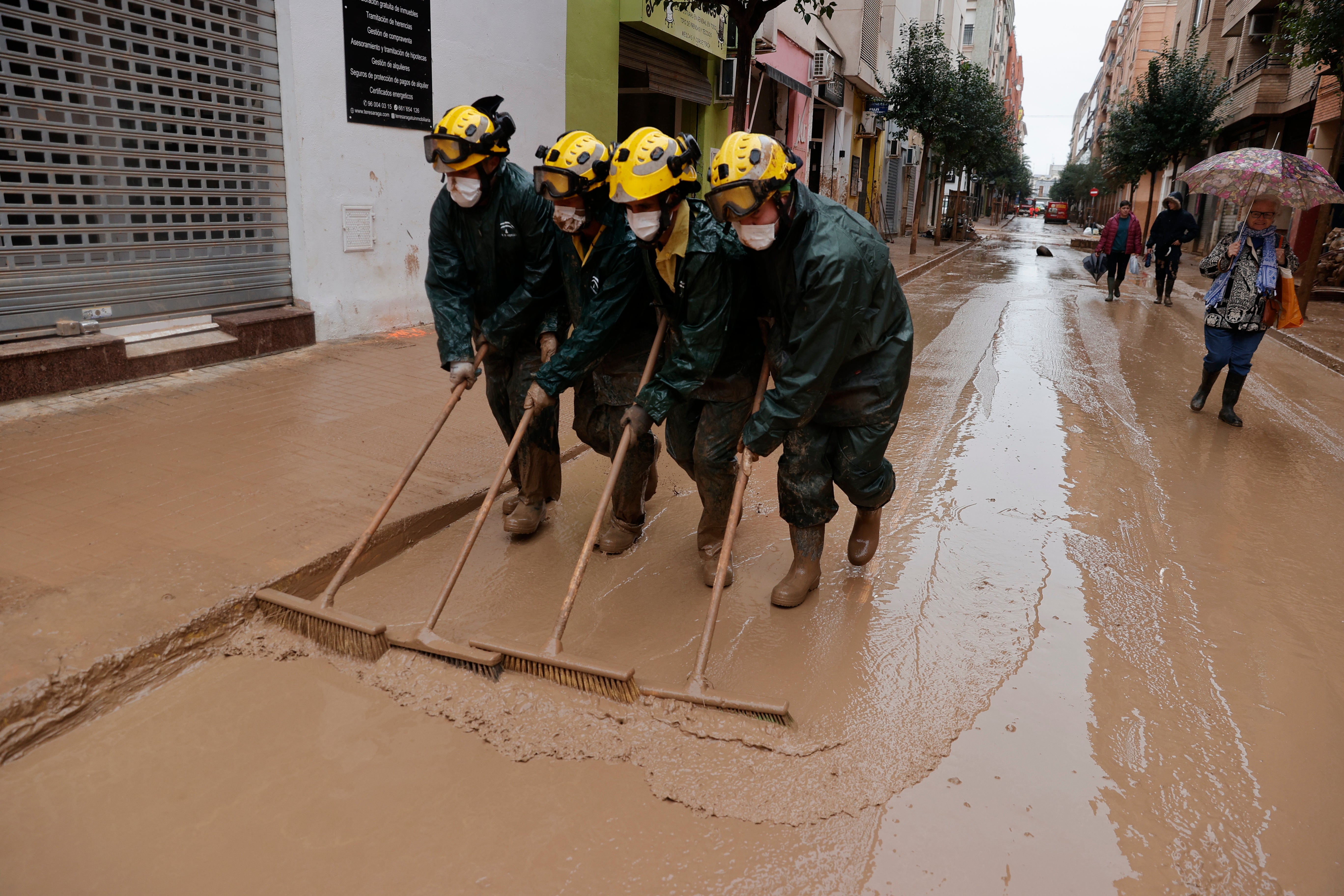 Firefighters in Valencia, eastern Spain, join the clean-up after a year’s-worth of rain fell in one day last month