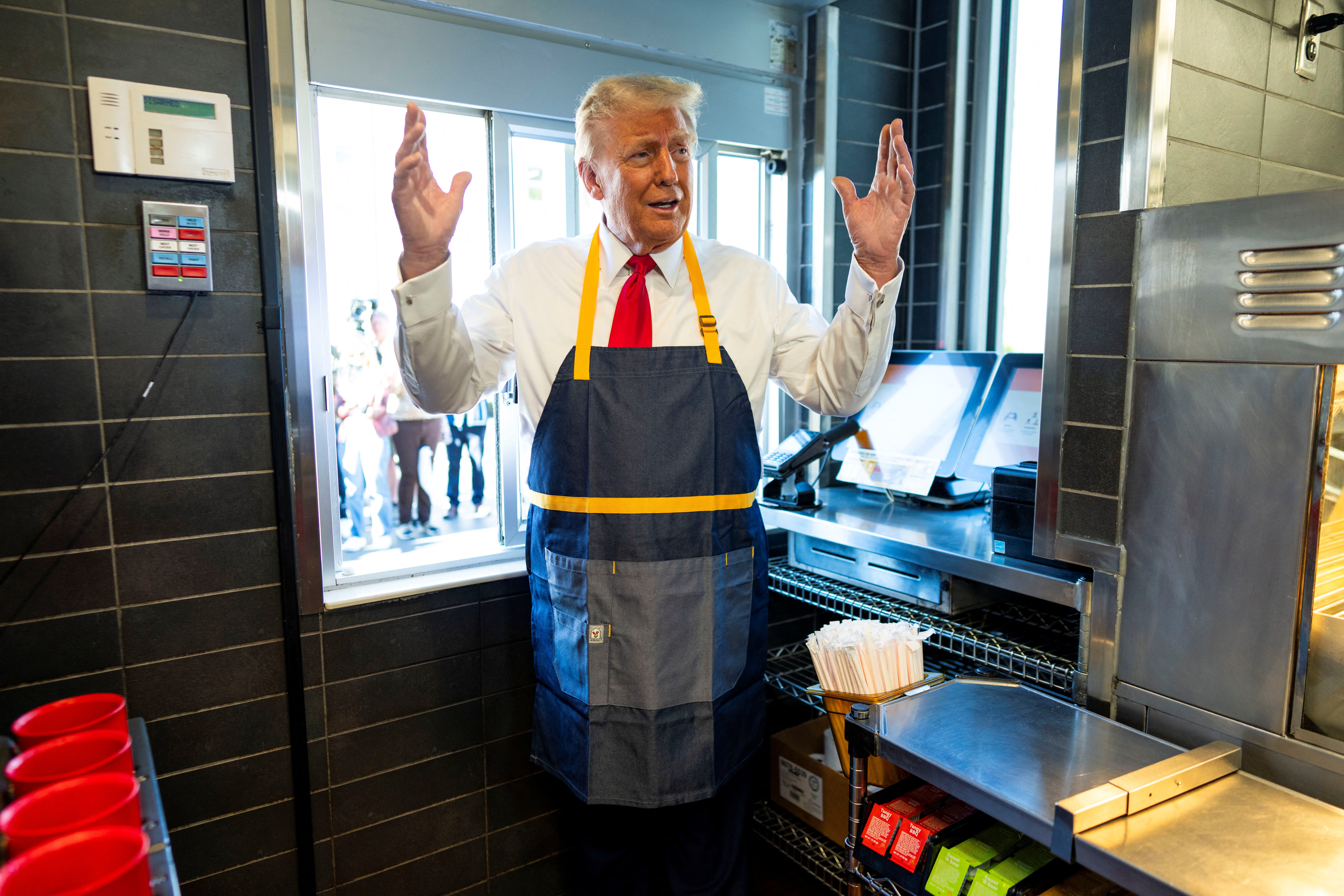 Donald Trump works behind the counter during a visit to McDonald’s in Feasterville-Trevose, Pennsylvania. Roughly 4 percent of bettors believe he will use the word “McDonald’s” during his inaugural address