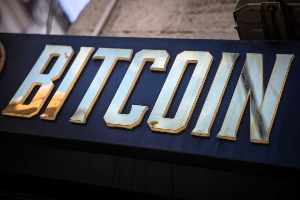 A gold bitcoin sign is seen at the entrance of a cryptocurrency exchange on 8 November, 2024 in Istanbul, Turkey