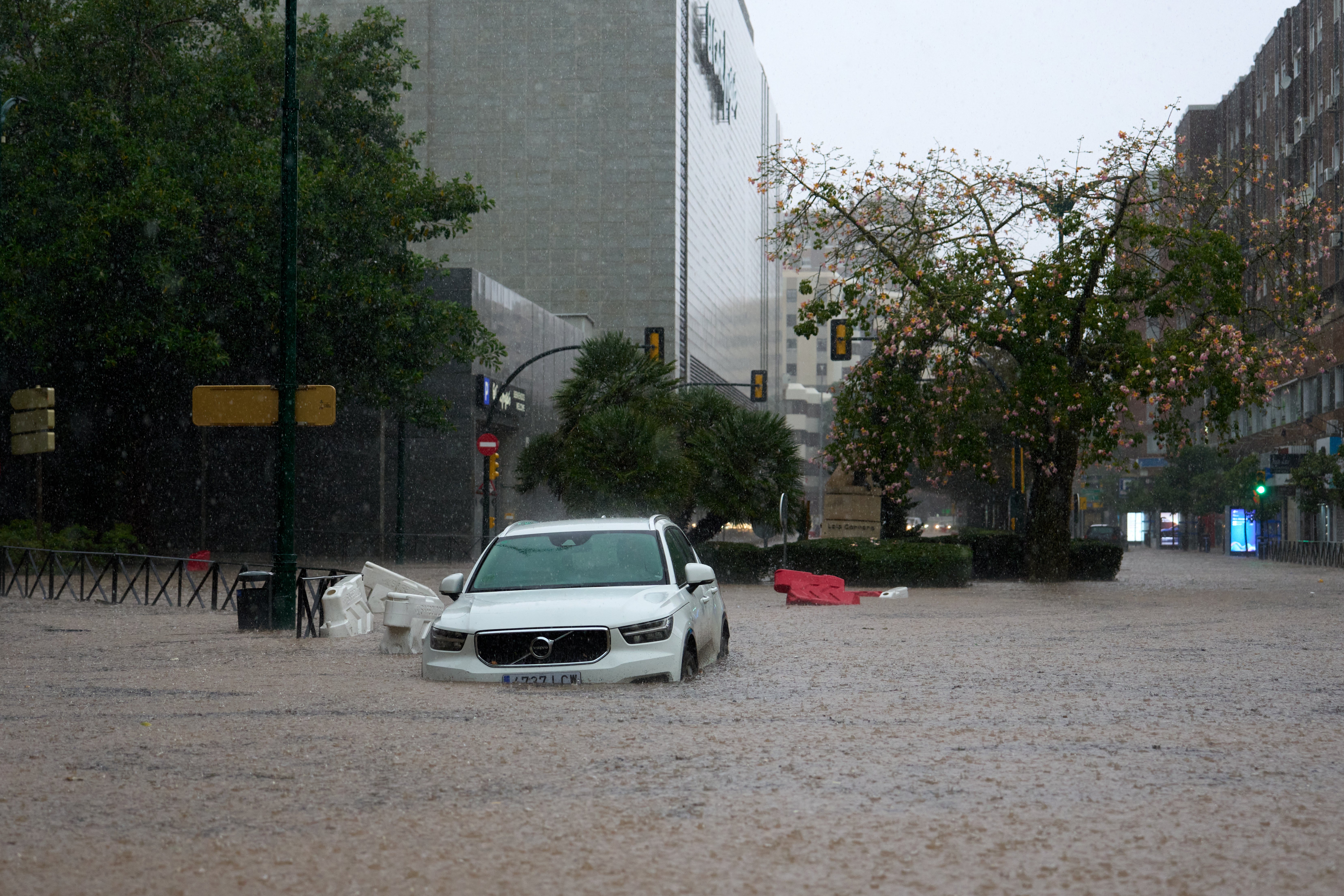 A car is partly submerged in flood waters on Wednesday in Malaga