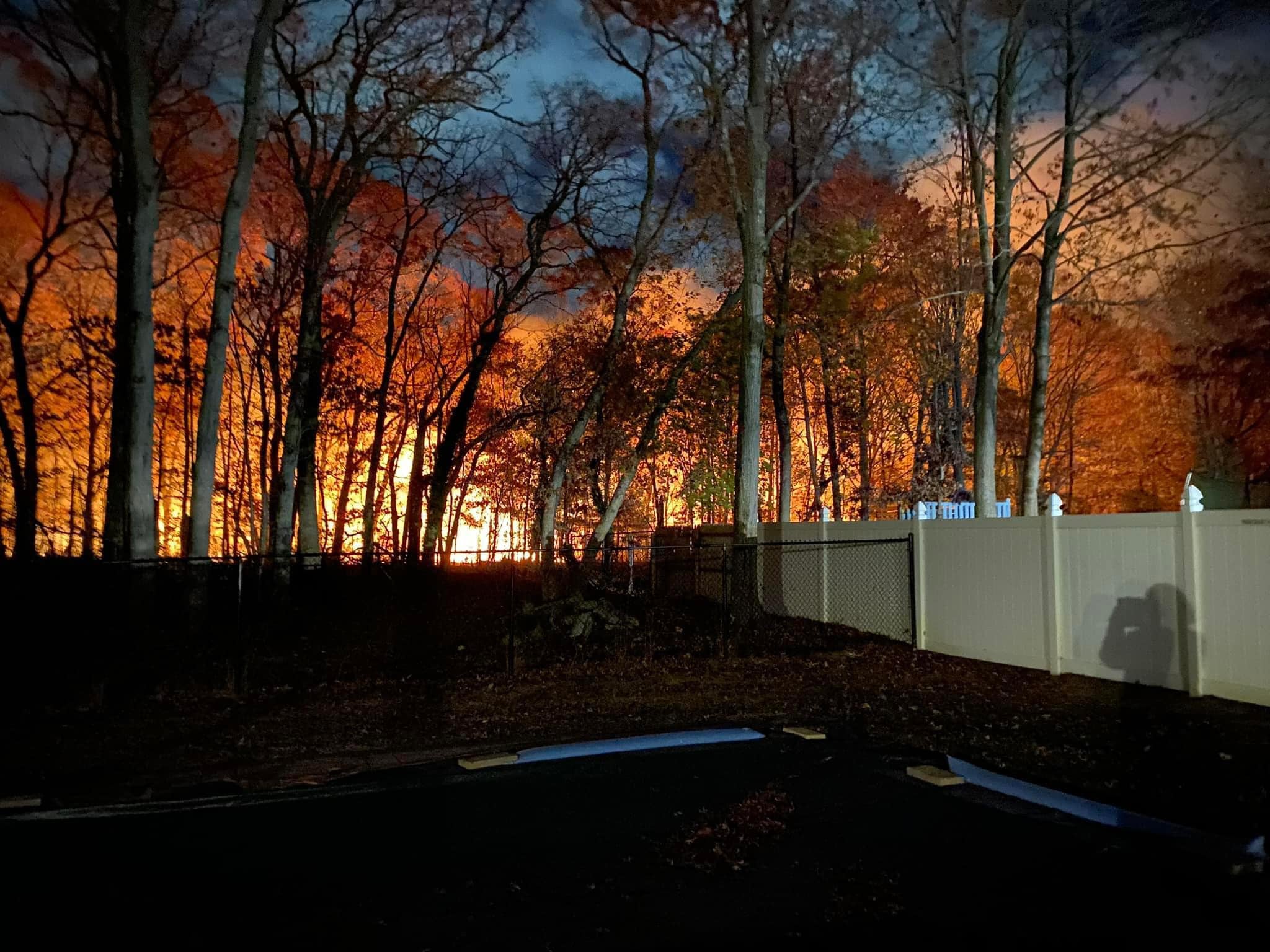 A brush fire is seen on New York’s Long Island hamlet of Medford. A volunteer firefighter was arrested this week on suspicion of starting a fire.