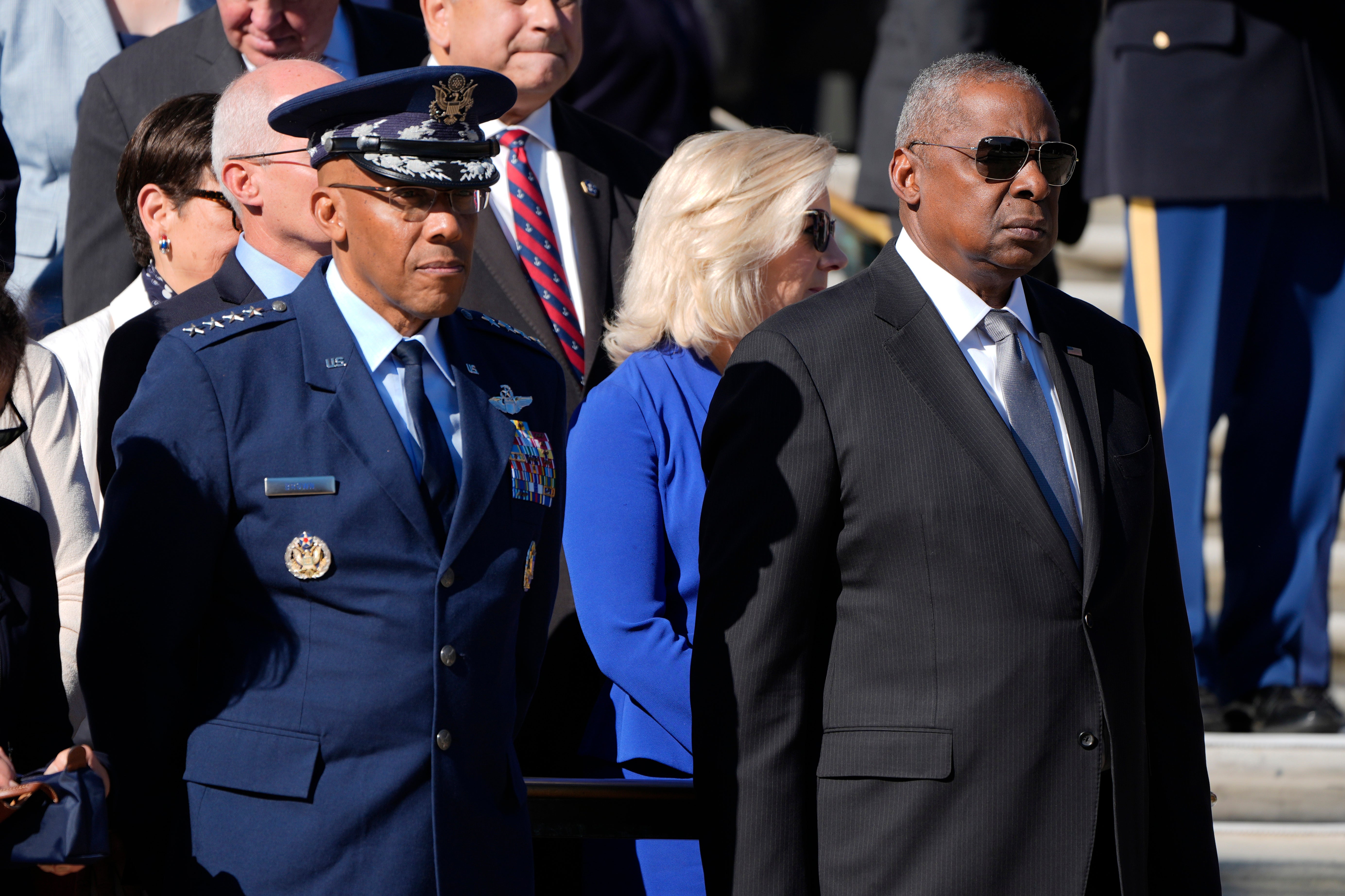 Chairman of the Joint Chiefs of Staff CQ Brown, left, and Defense Secretary Lloyd Austin attend a wreath laying ceremony at Arlington National Cemetery on November 11