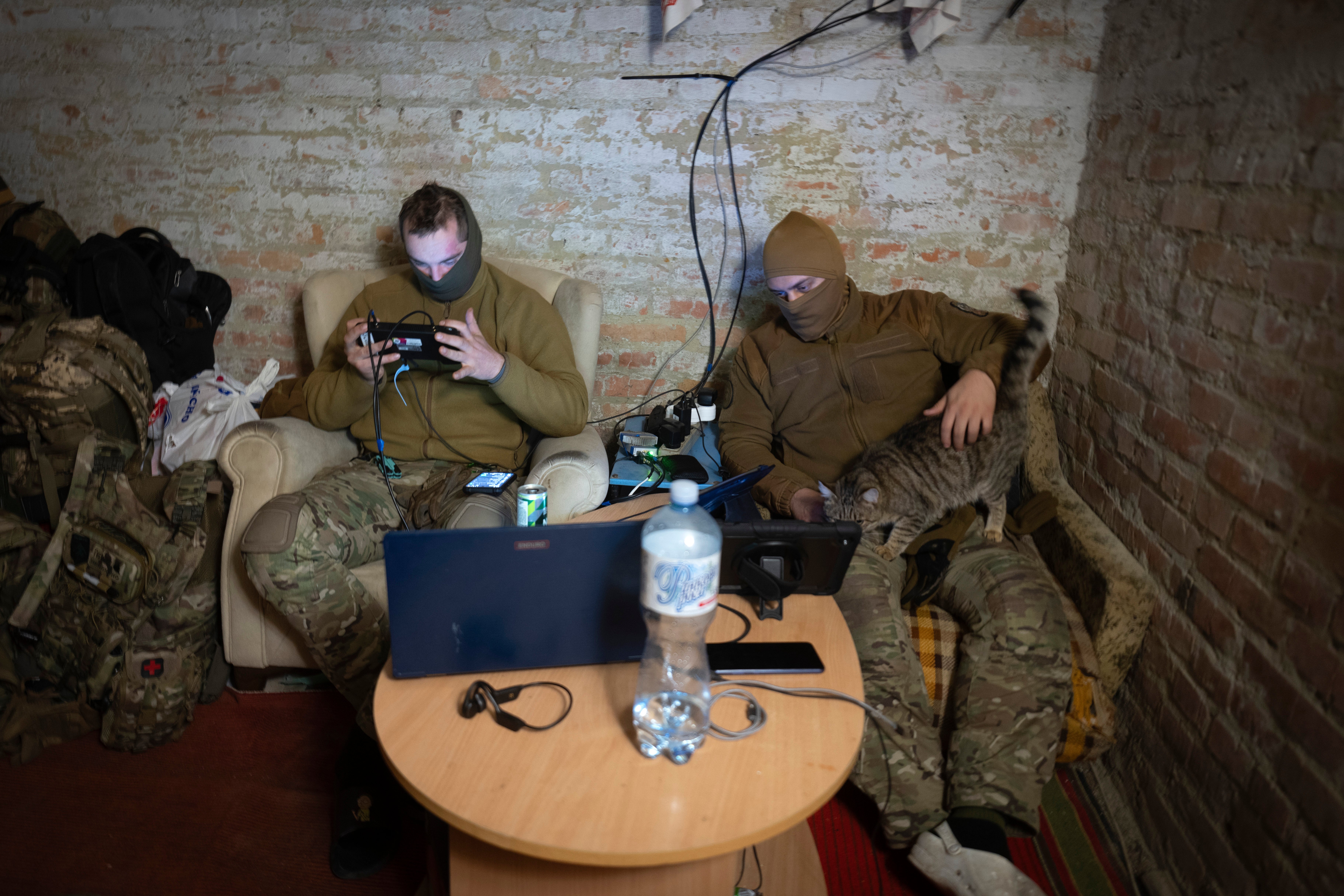 Servicemen of Ukraine's Khartia brigade pilot drones in a shelter on the frontline near Kharkiv, Ukraine