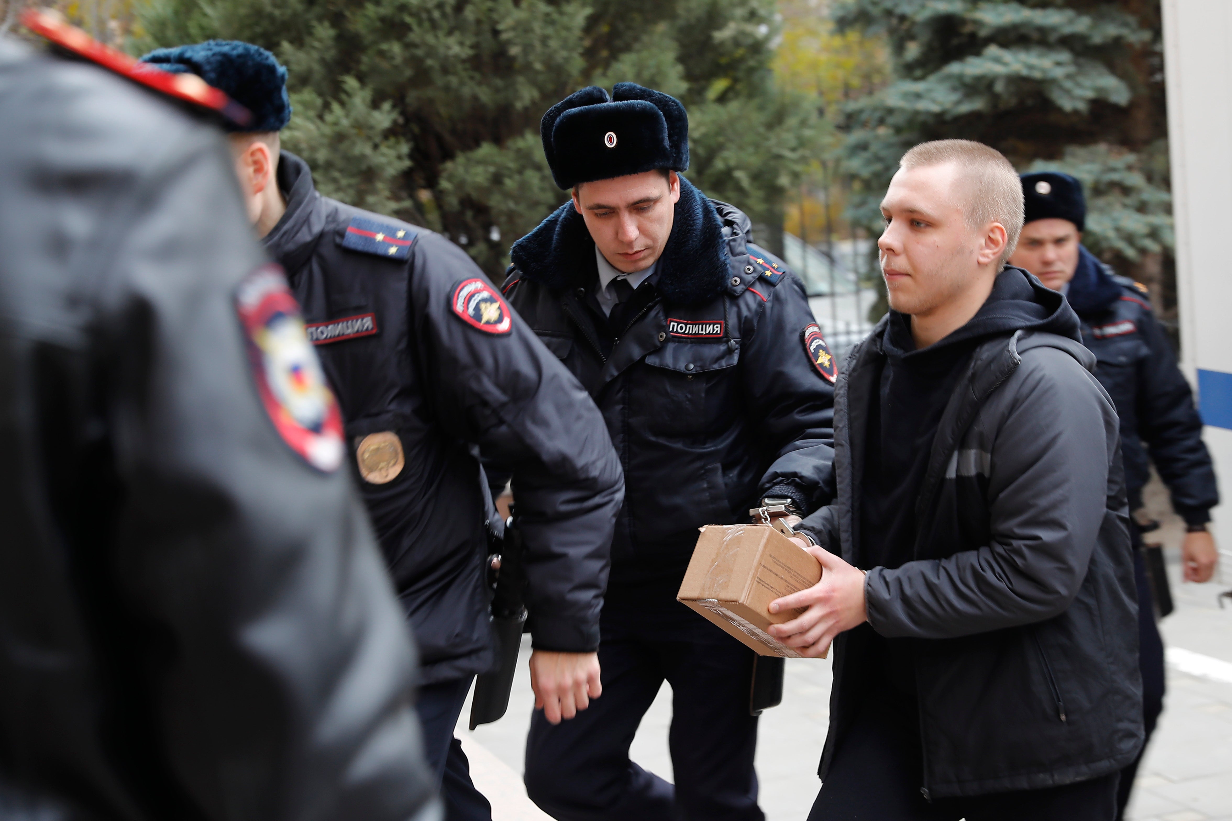 Nikita Zhuravel is escorted by the police to a court prior to a hearing of a treason case in Volgograd, Russia, on Thursday