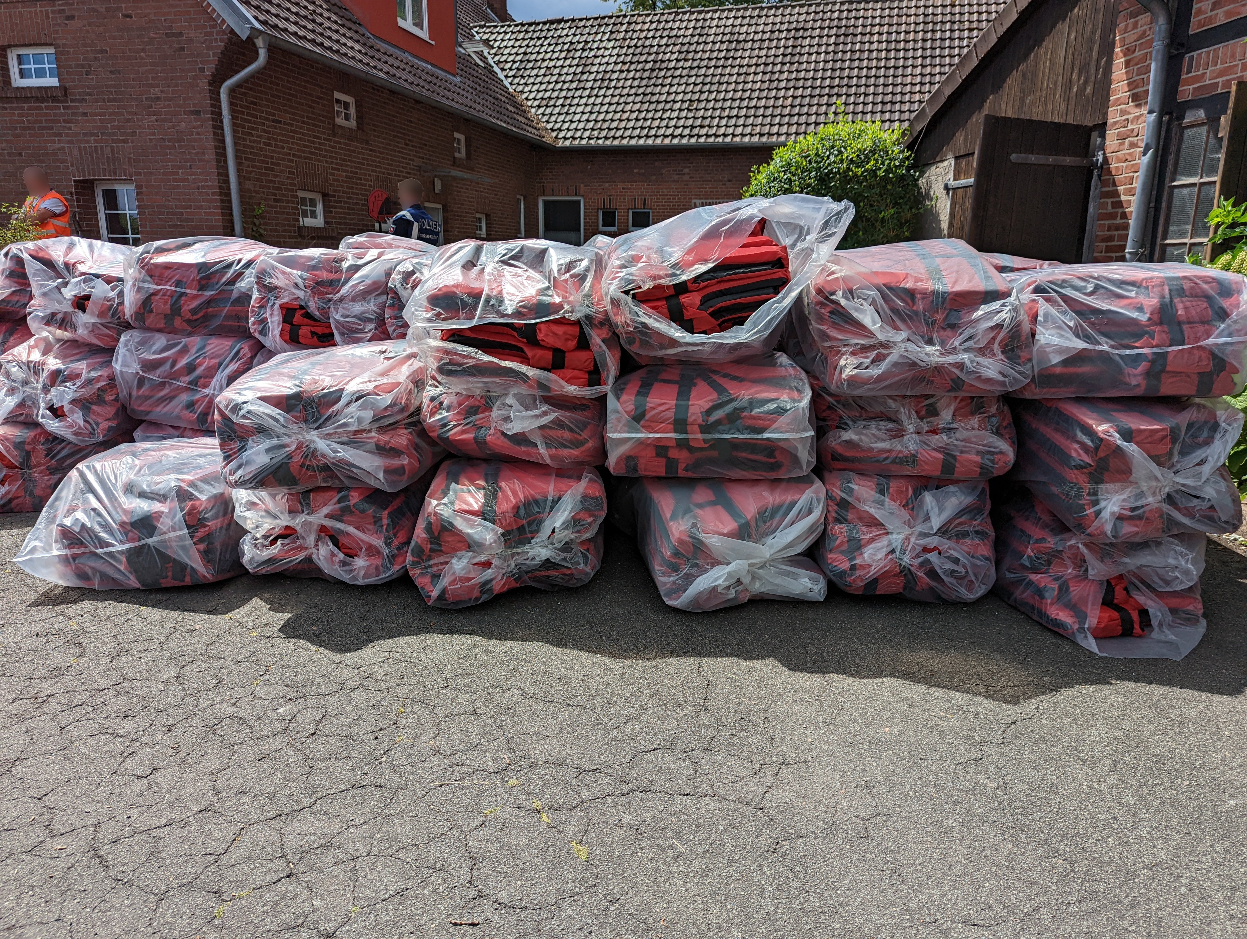 Dozens of life jackets are seen in Germany, alleged to have been supplied to people smugglers helping people cross the English Channel