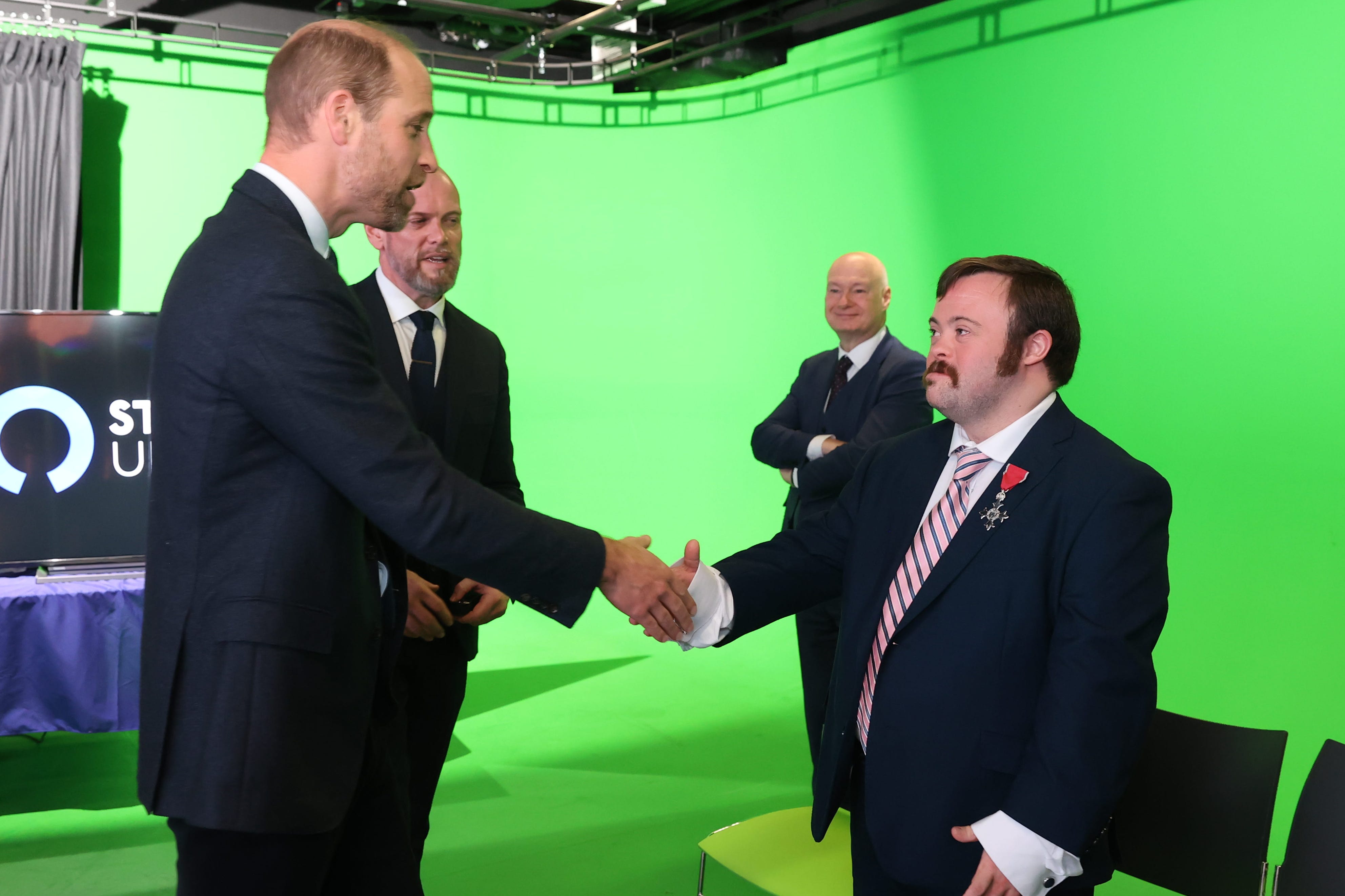 The Prince of Wales meets Belfast-born actor, James Martin during a visit to Ulster University (Liam McBurney/PA)