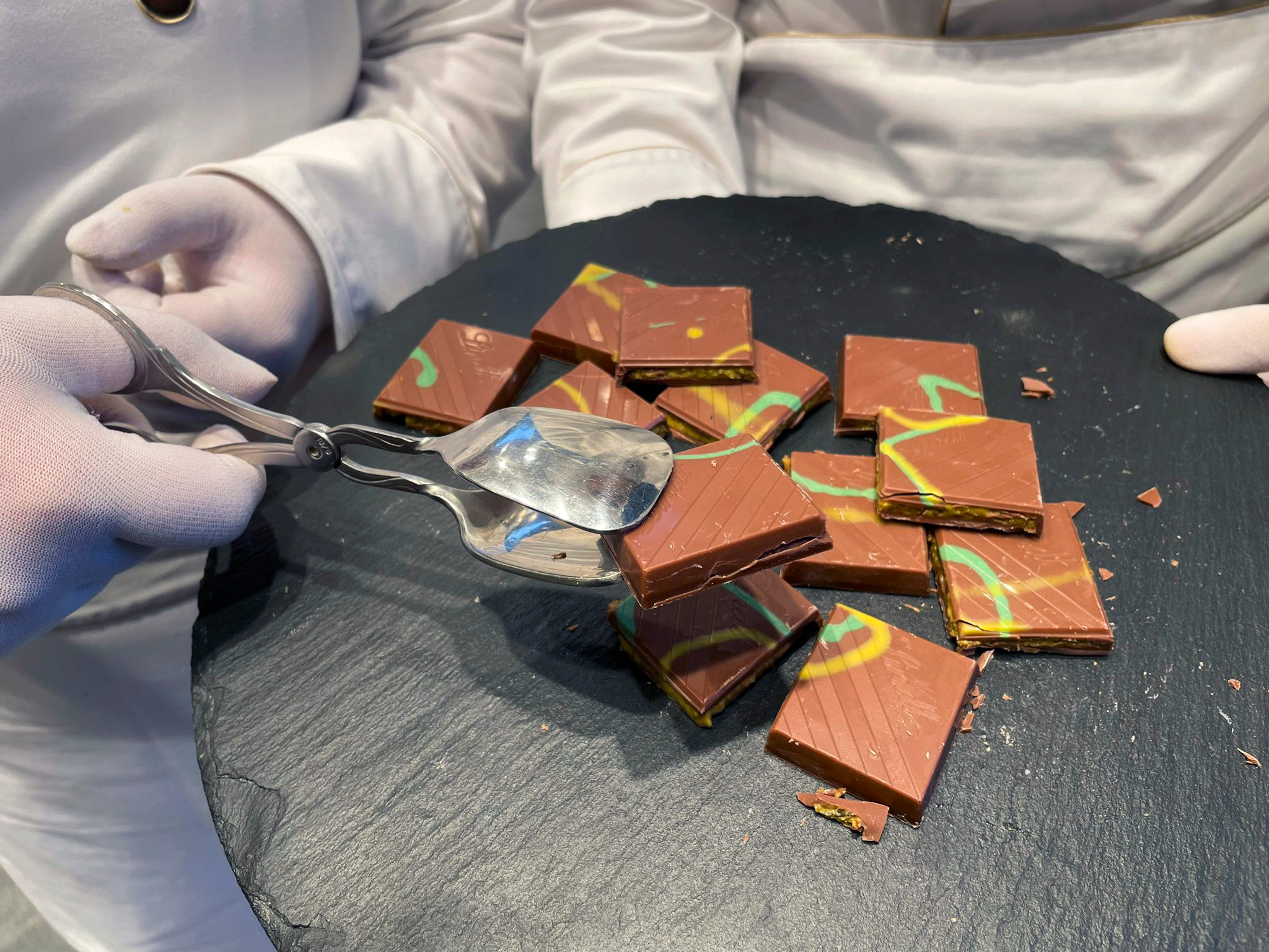 Service employees offer ‘Dubai Chocolate’ in a Lindt shop to customers during the sell of limited bars