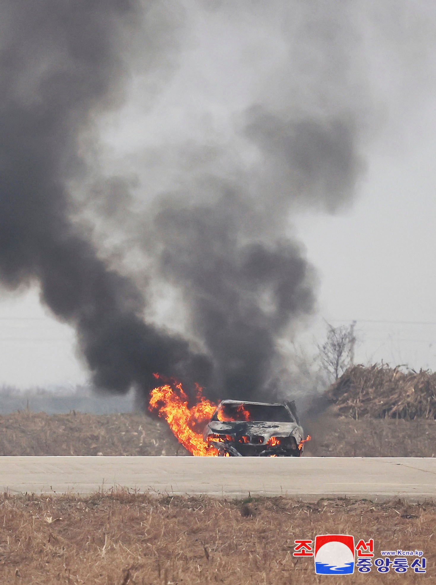 This photo provided by the North Korean government shows a burning vehicle during tests of drones designed to crash into targets at an undisclosed location in North Korea