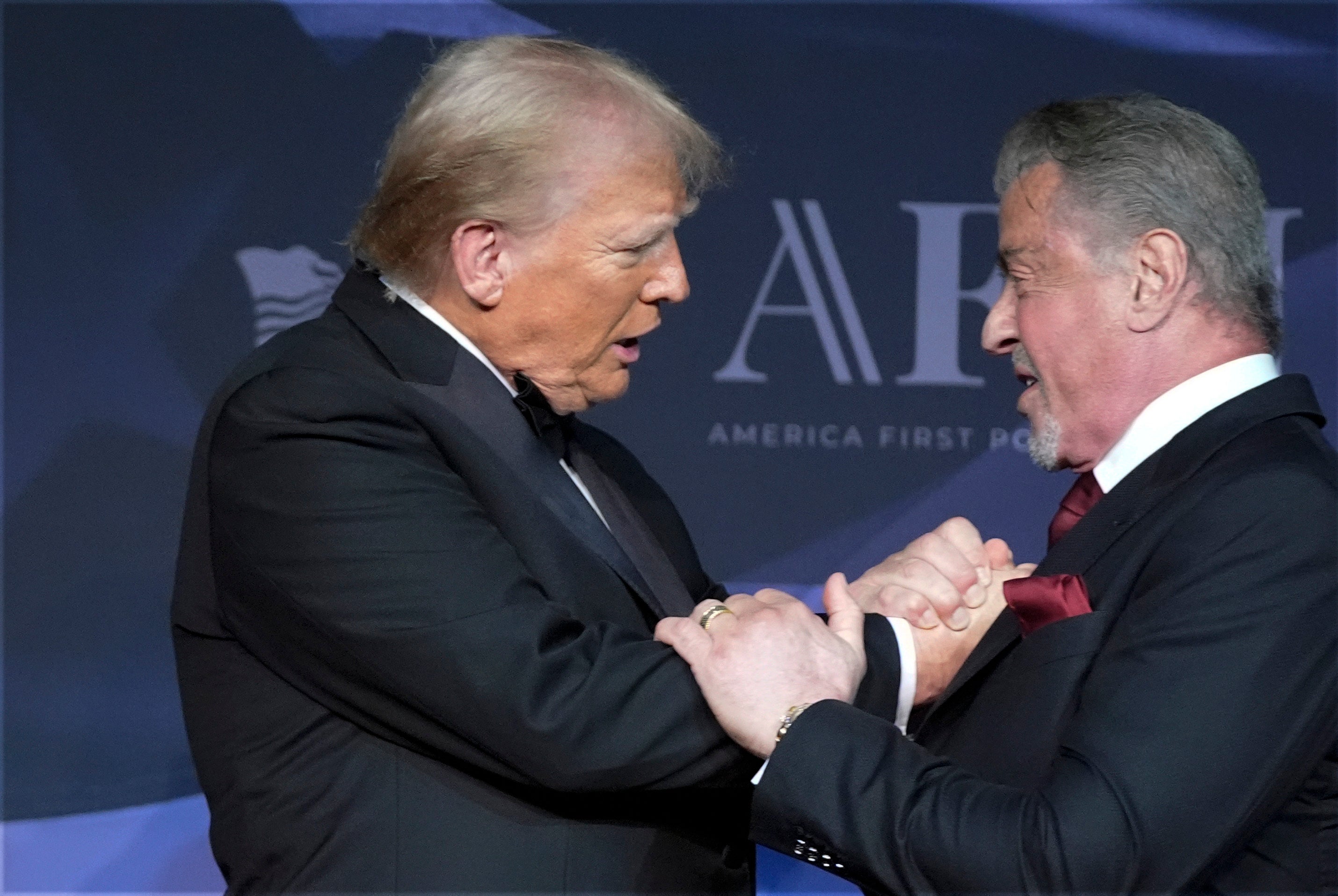 President-elect Donald Trump greets actor Sylvester Stallone during an America First Policy Institute gala at his Mar-a-Lago estate