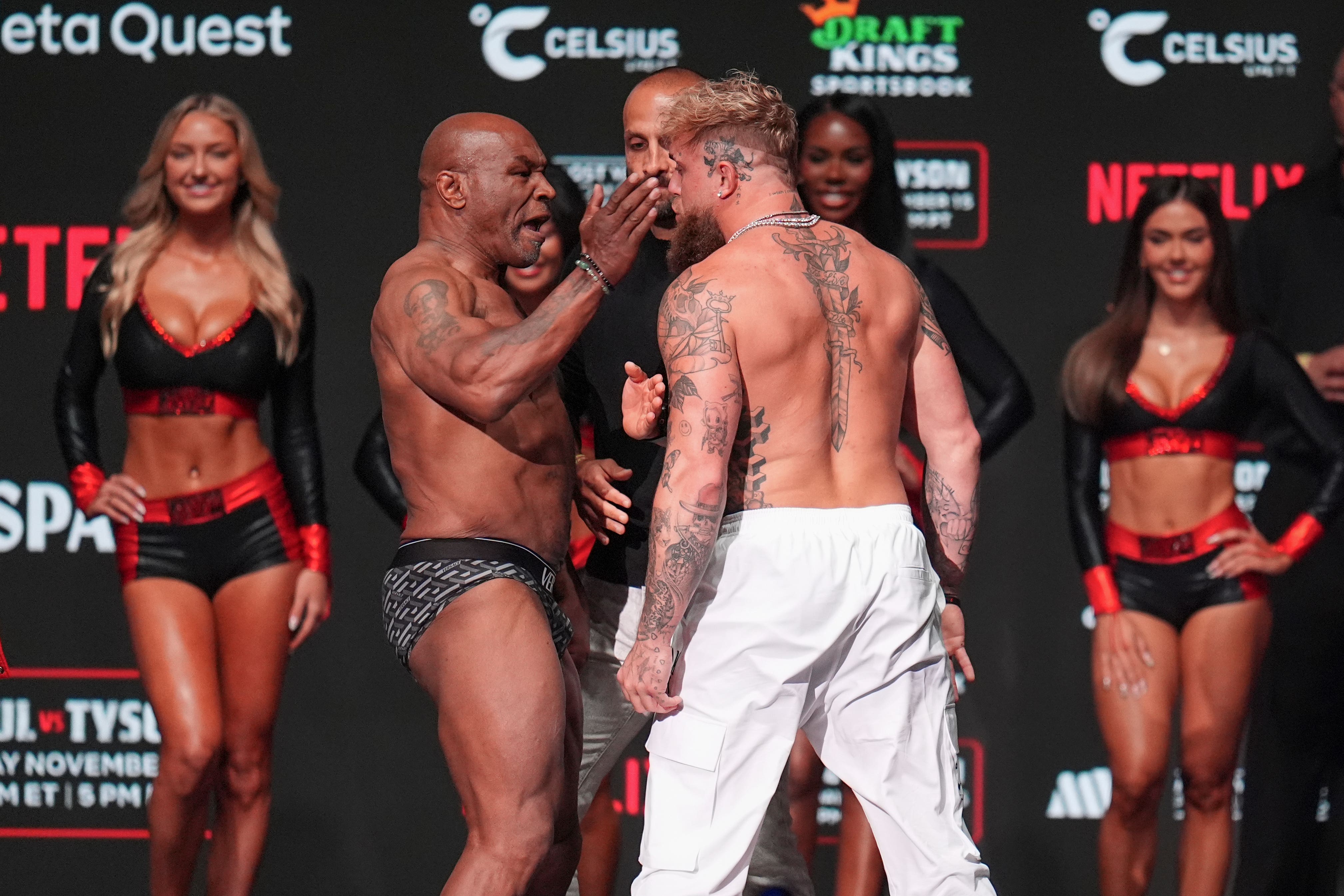 Mike Tyson, left, slaps Jake Paul during a weigh-in ahead of their heavyweight bout,(Julio Cortez/AP)