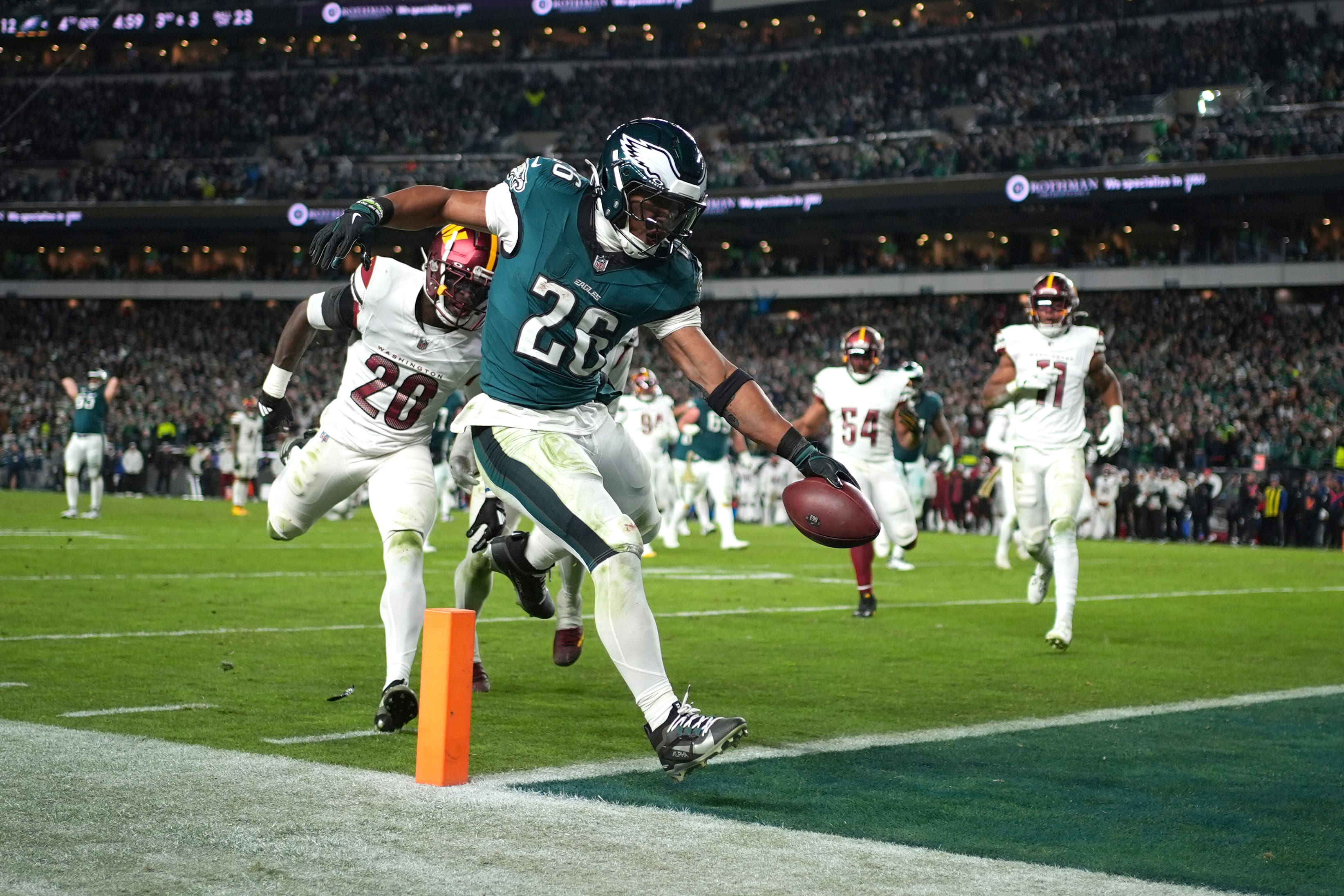 Philadelphia Eagles running back Saquon Barkley (26) scores during the second half of an NFL football game against the Washington Commanders (AP Photo/Matt Slocum)