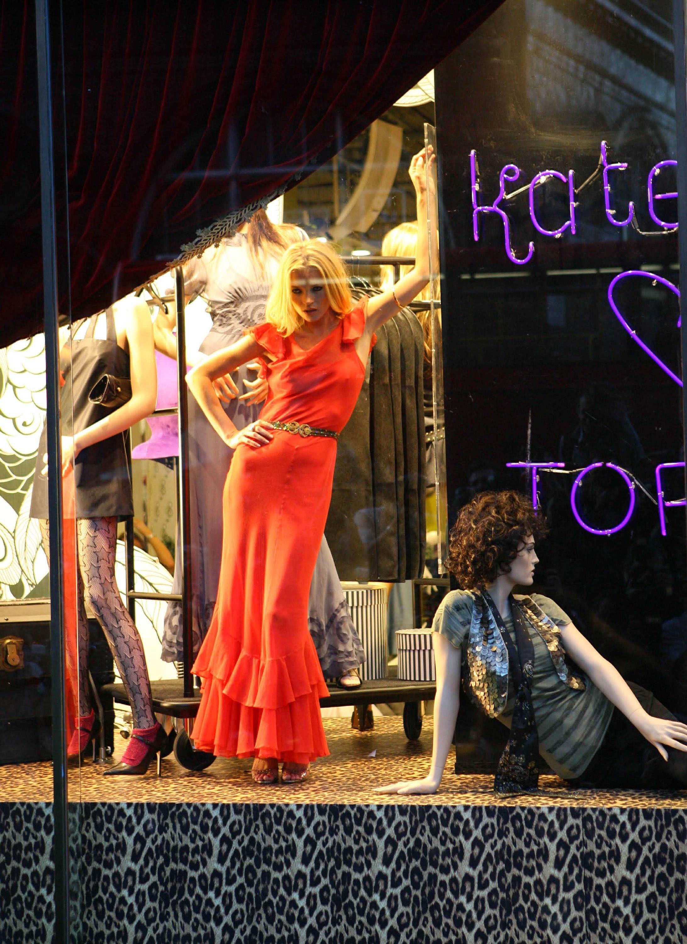 Moss posed in the shop window alongside the mannequins wearing her collection (Alamy/PA)