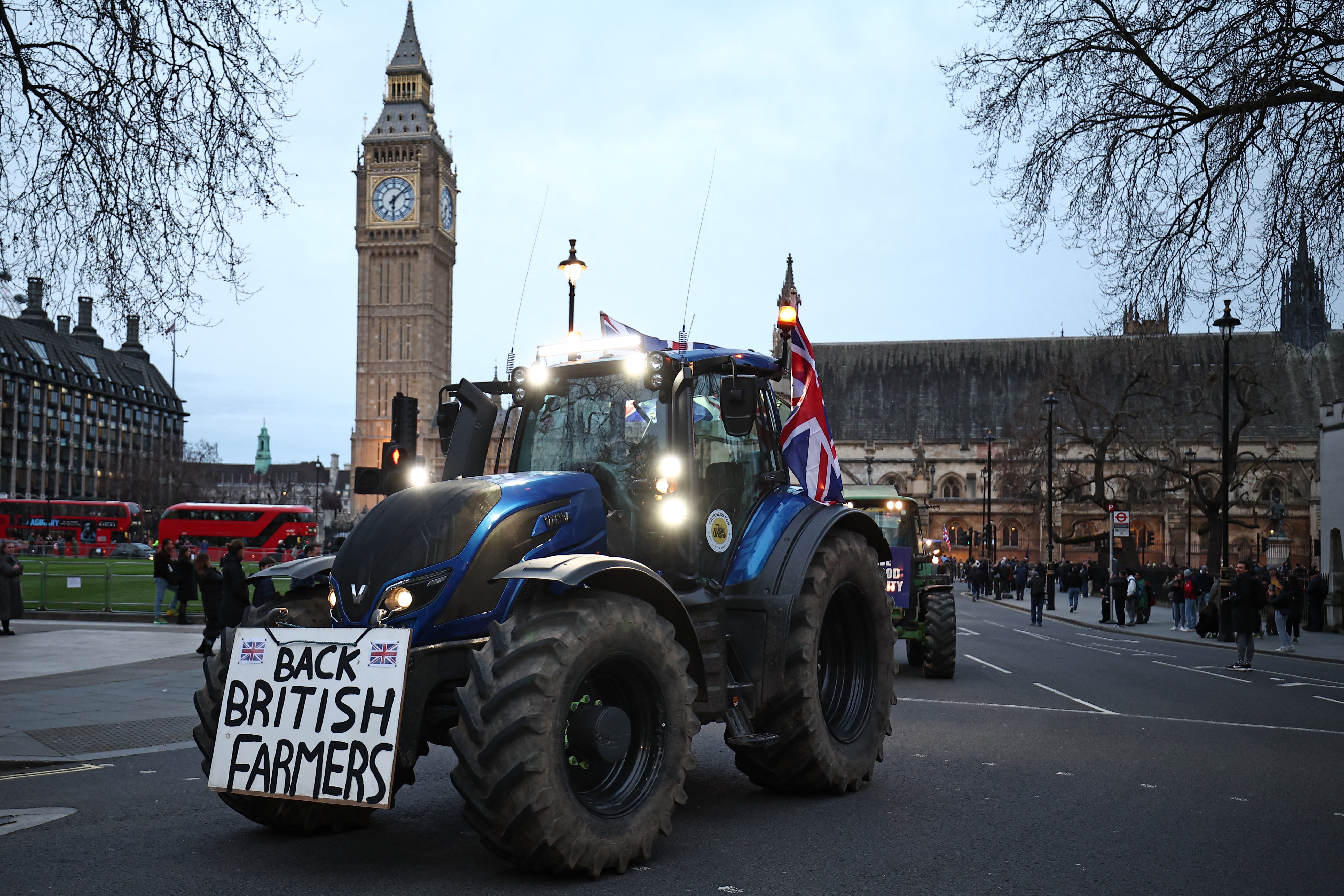 Farmers drive tractors around Parliament Square during a demonstration organised by Save British Farming, March 2024