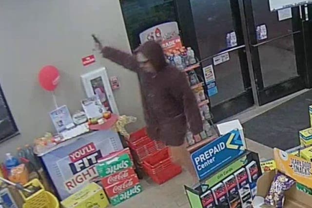 <p>Samuel James Collins, 34, is seen in surveillance footage staging armed robbery at a Town Pump gas station in Townsend, near Great Falls</p>