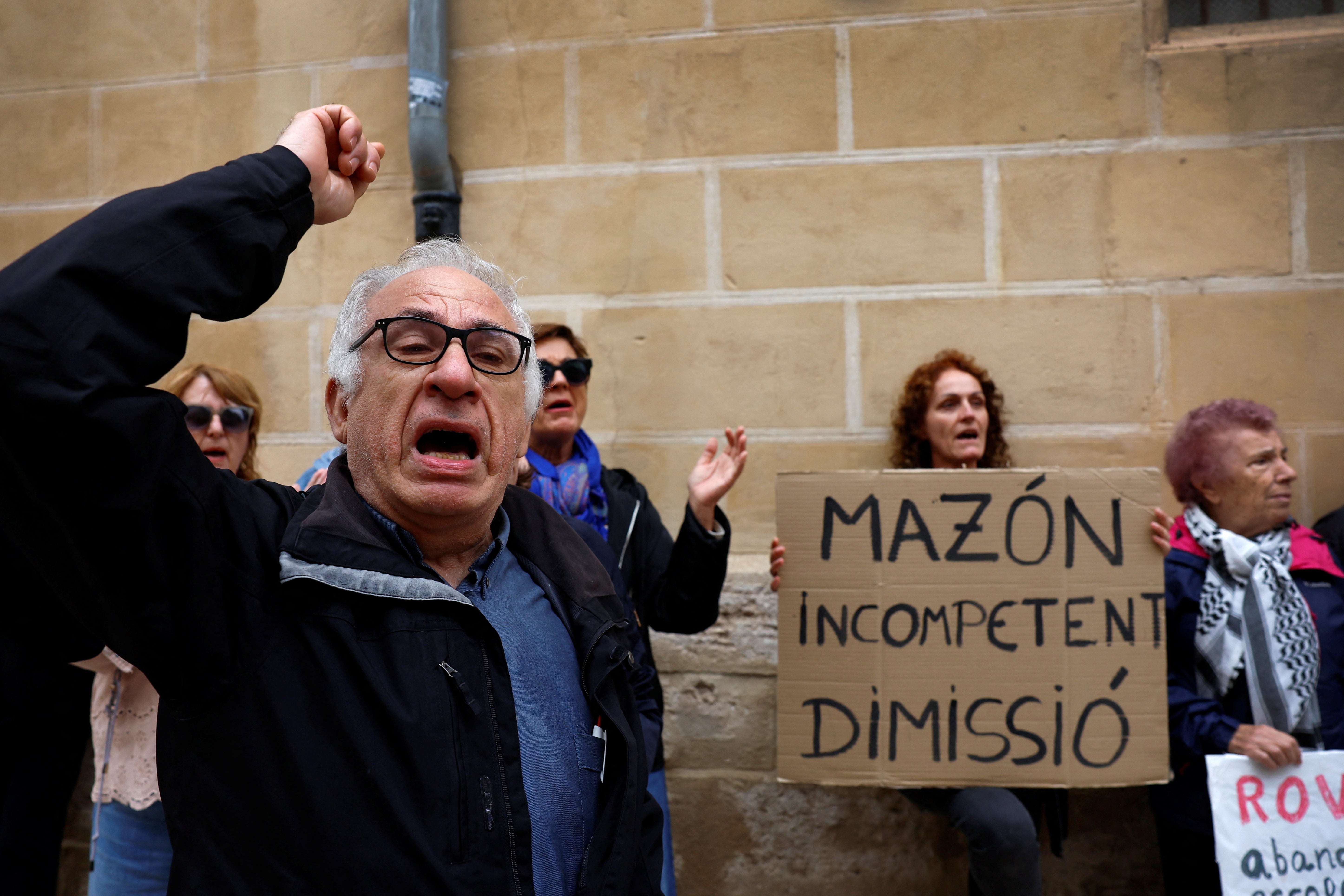 Protesters gather in front of the regional parliament building