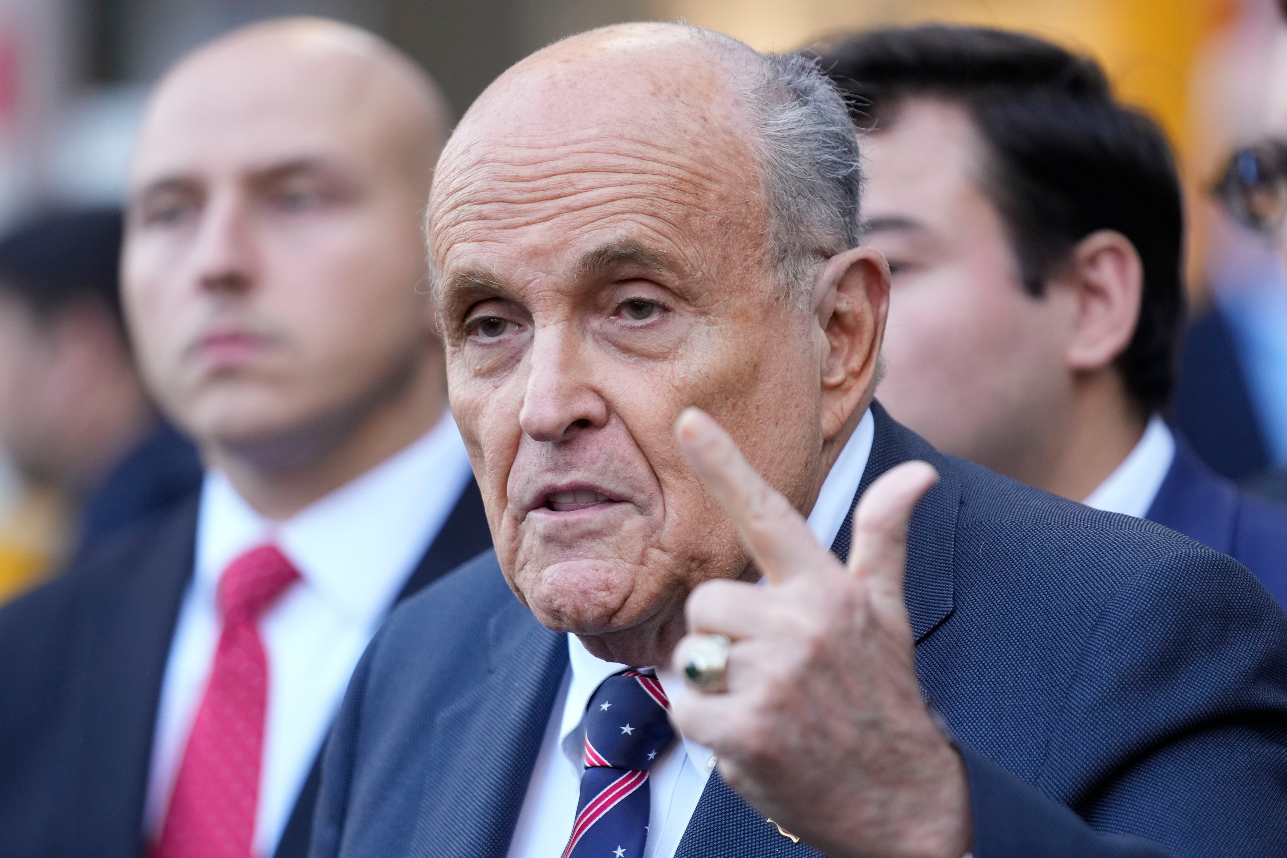 Former New York City Mayor Rudy Giuliani speaks to the media as he leaves court in New York on November 7. He is asking the federal judge to delay his defamation trial until after Donald Trump’s inauguration