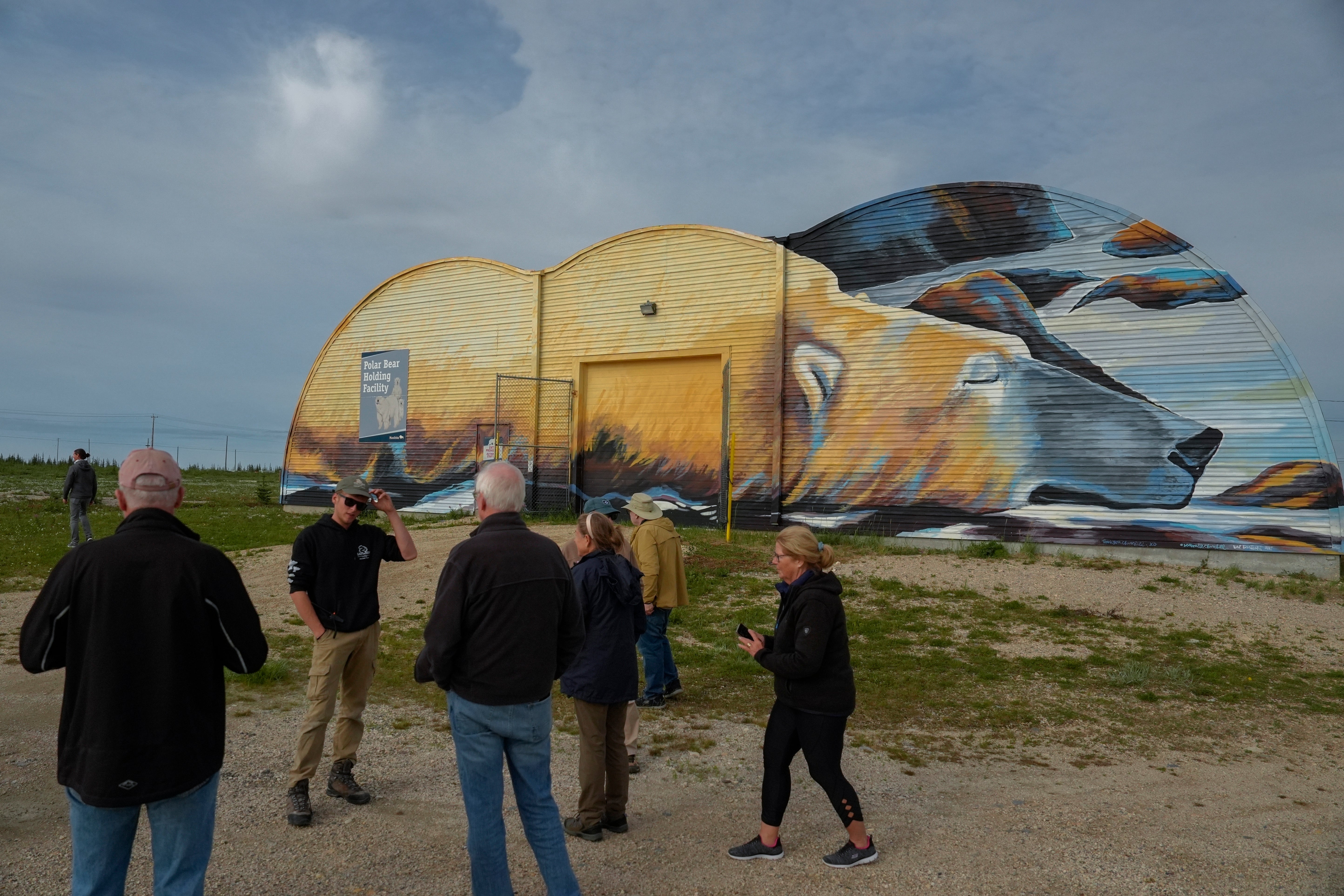 Tourists stand outside the Polar Bear Holding Facility, Sunday, Aug. 4, 2024, in Churchill, Manitoba