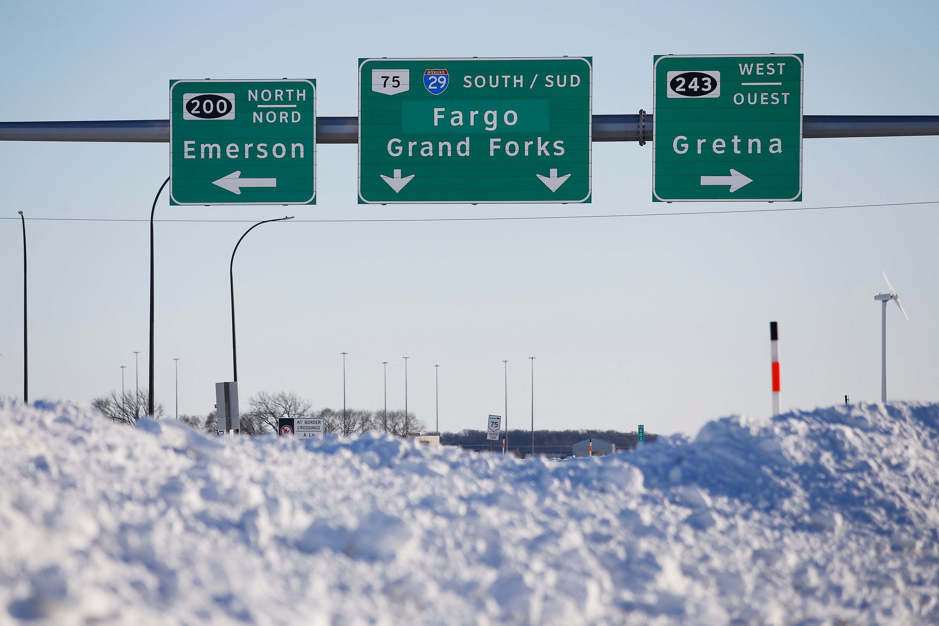 Road signage is posted just outside of Emerson, Manitoba, Jan. 20, 2022.