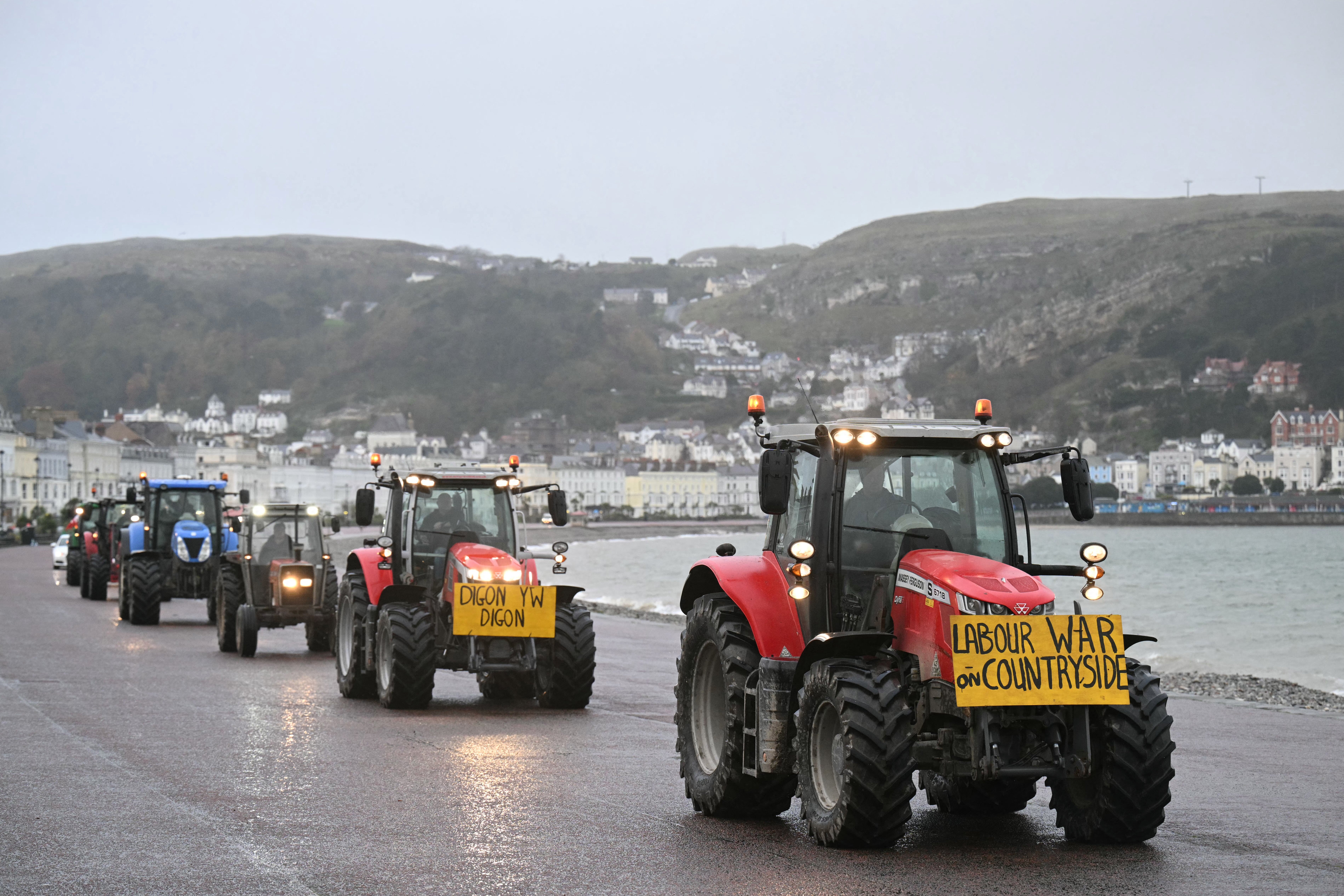 Tractors are driven along the promenade to the venue of the Welsh Labour Party conference in Llandudno