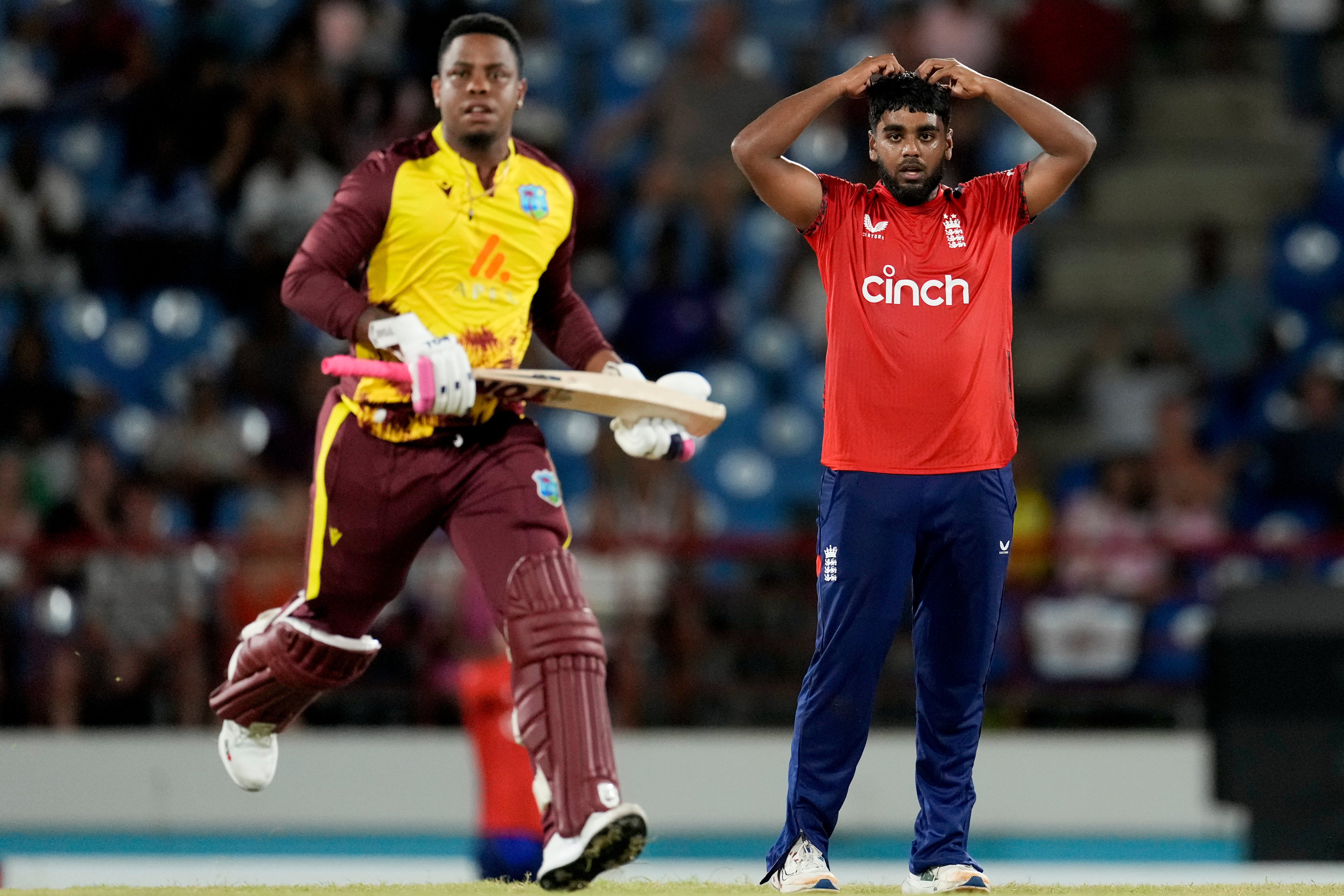 England’s bowler Rehan Ahmed reacts as West Indies’ Shimron Hetmyer runs (Ricardo Mazalan/AP)