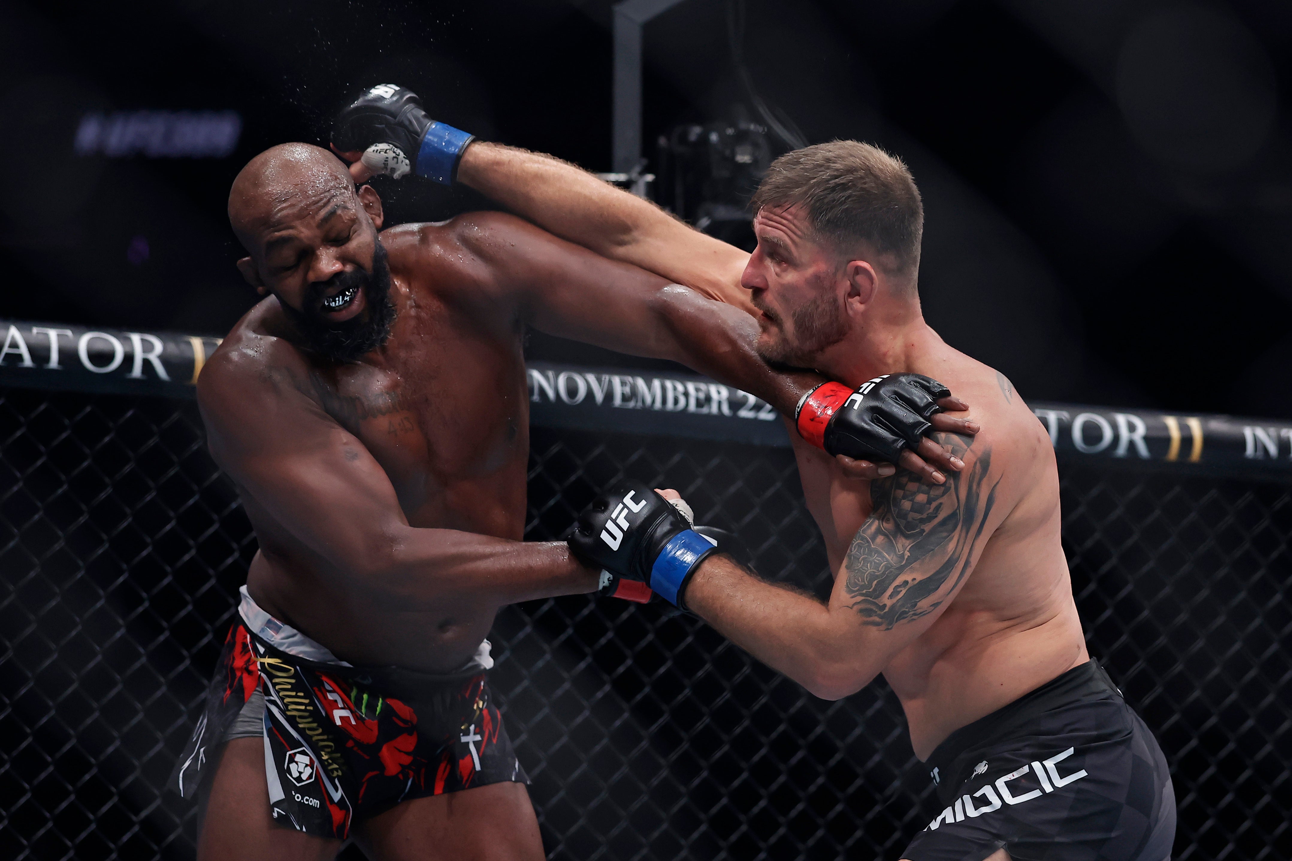 Jon Jones (left) during his final fight, a win over Stipe Miocic in November