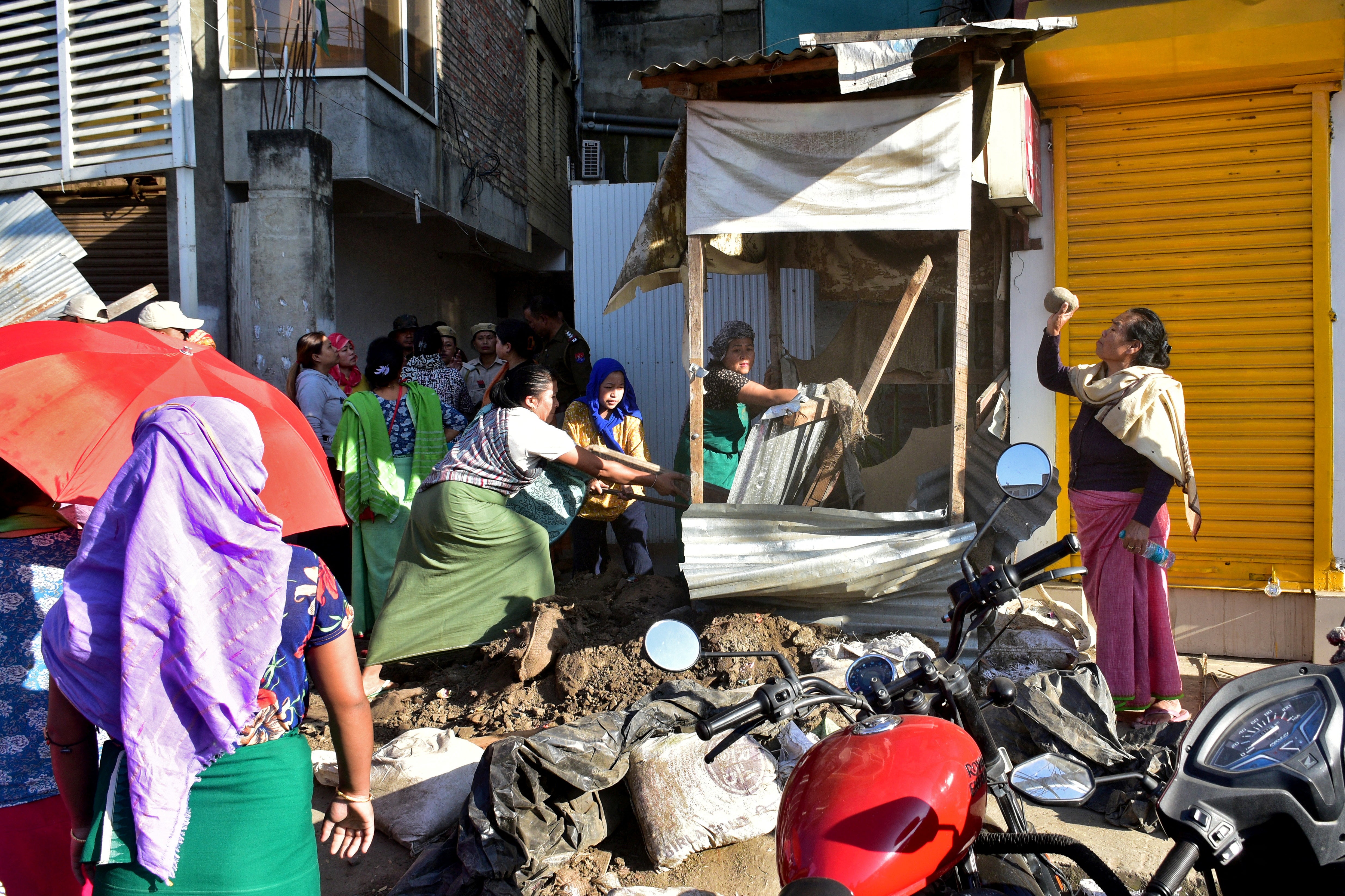 Demonstrators demolish a security bunker outside the residence of a lawmaker during a protest against the recent killings