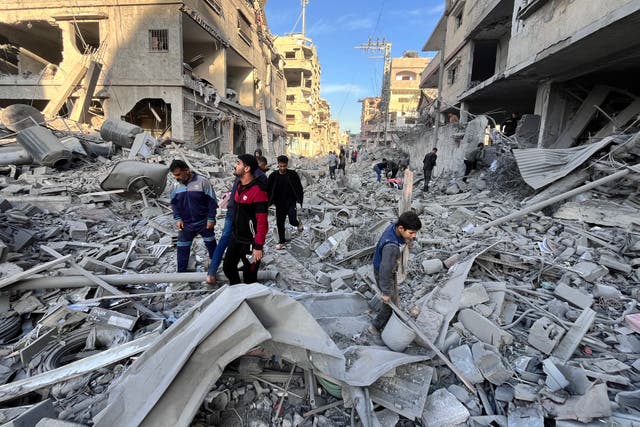 <p>People check the rubble after a devastating overnight Israeli strike in Beit Lahya</p>