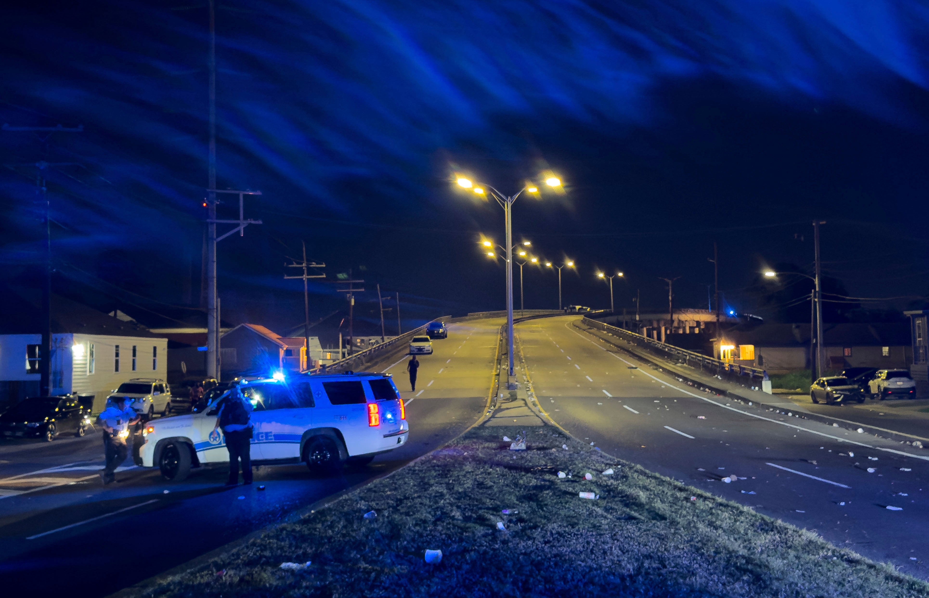 New Orleans Police block the Almonaster Avenue Bridge after a deadly shooting during a second line celebration