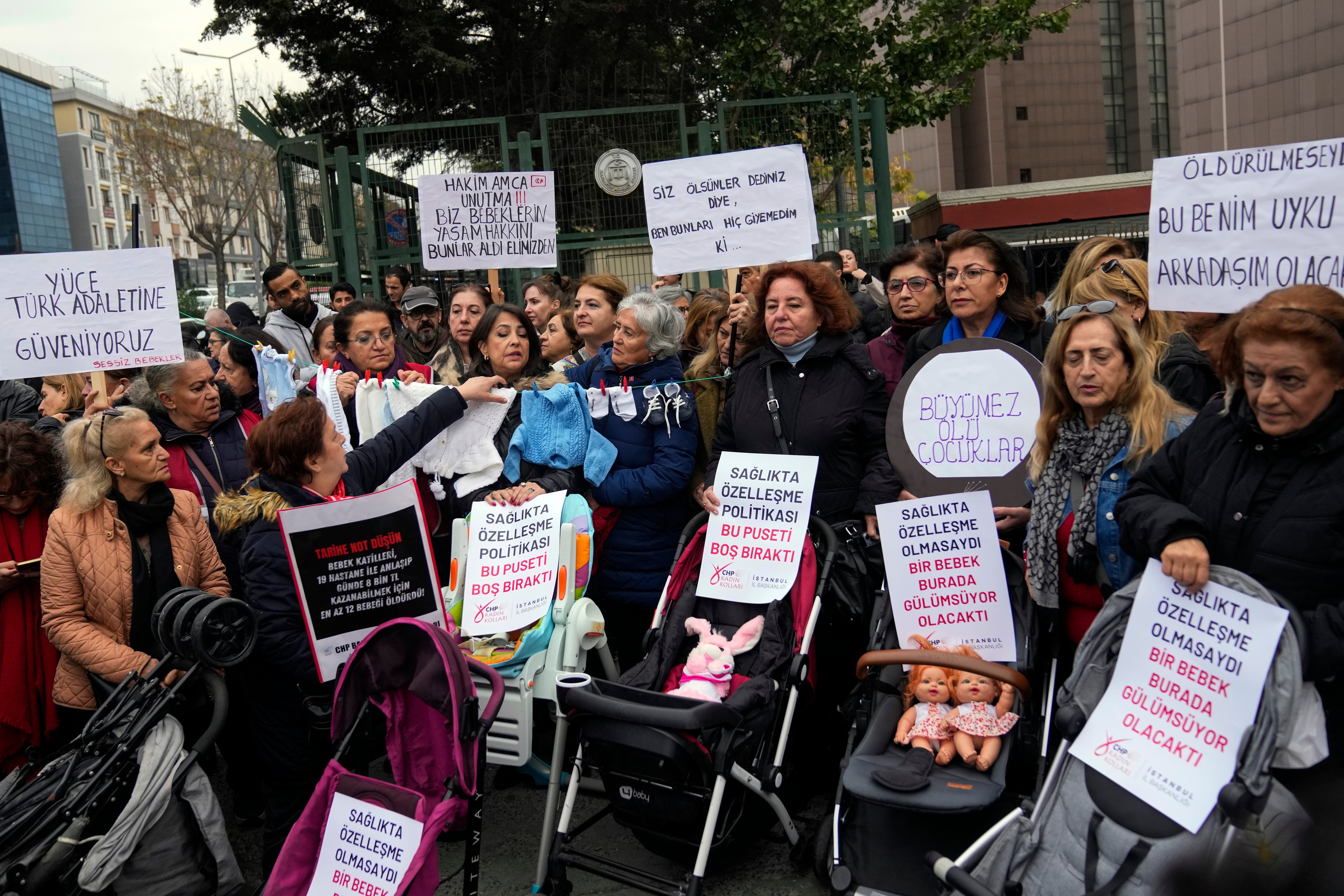 Activists, some holding banners with Turkish writing that some of them reads, " Children should not be killed , so they can eat candies", " I couldn't play with my toys because I was killed" and " If I had not been killed this toy would have been my sleeping friend " during a protest outside the courthouse where dozens of Turkish healthcare workers including doctors and nurses go on trial for fraud and causing the deaths of 10 infants, in Istanbul, Turkey, Monday Nov, 18, 2024