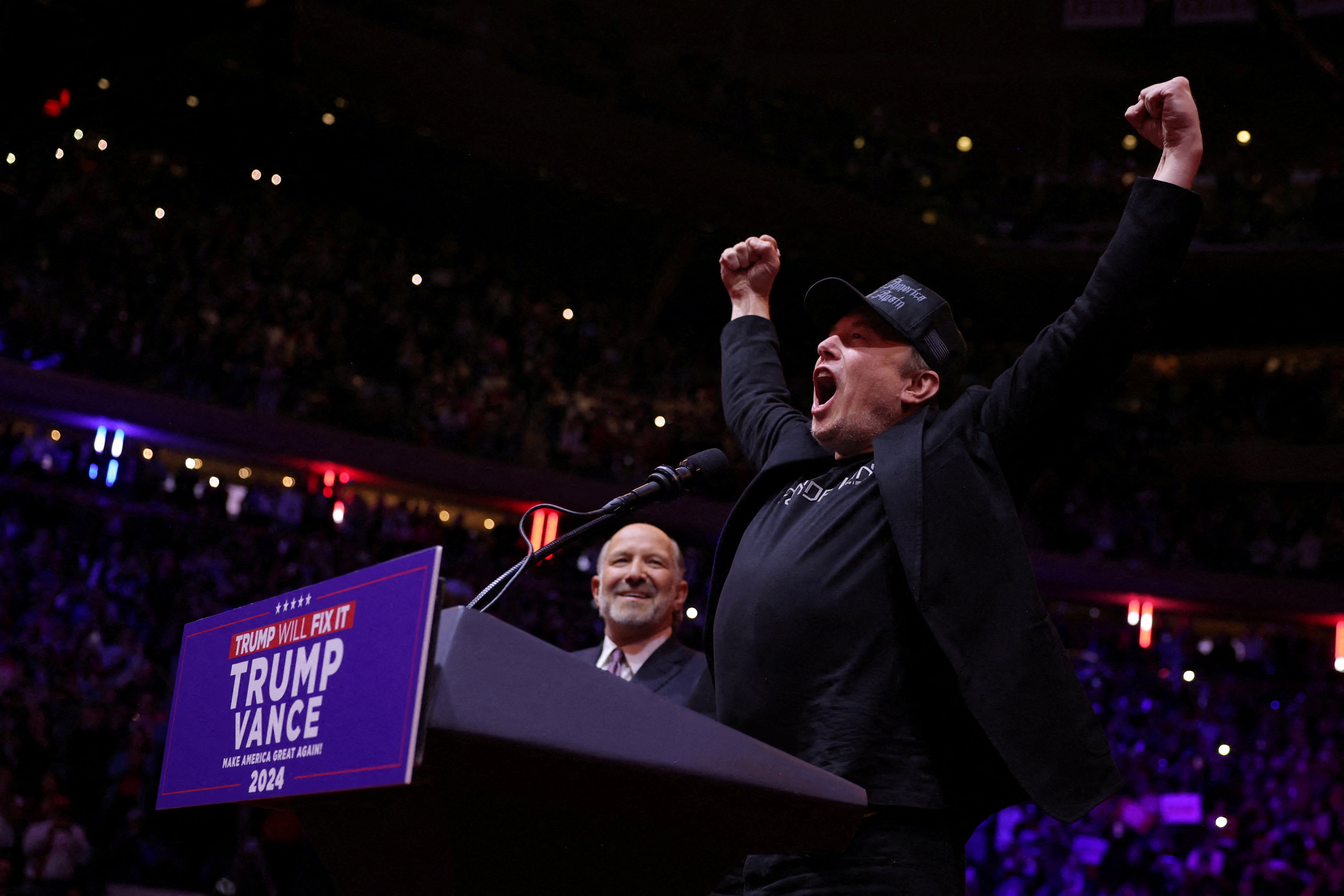 Elon Musk on stage next to Howard Lutnick at a Trump rally at Madison Square Garden, in New York, on October 27. Lutnick appears to have fallen down the pecking order for the cabinet role