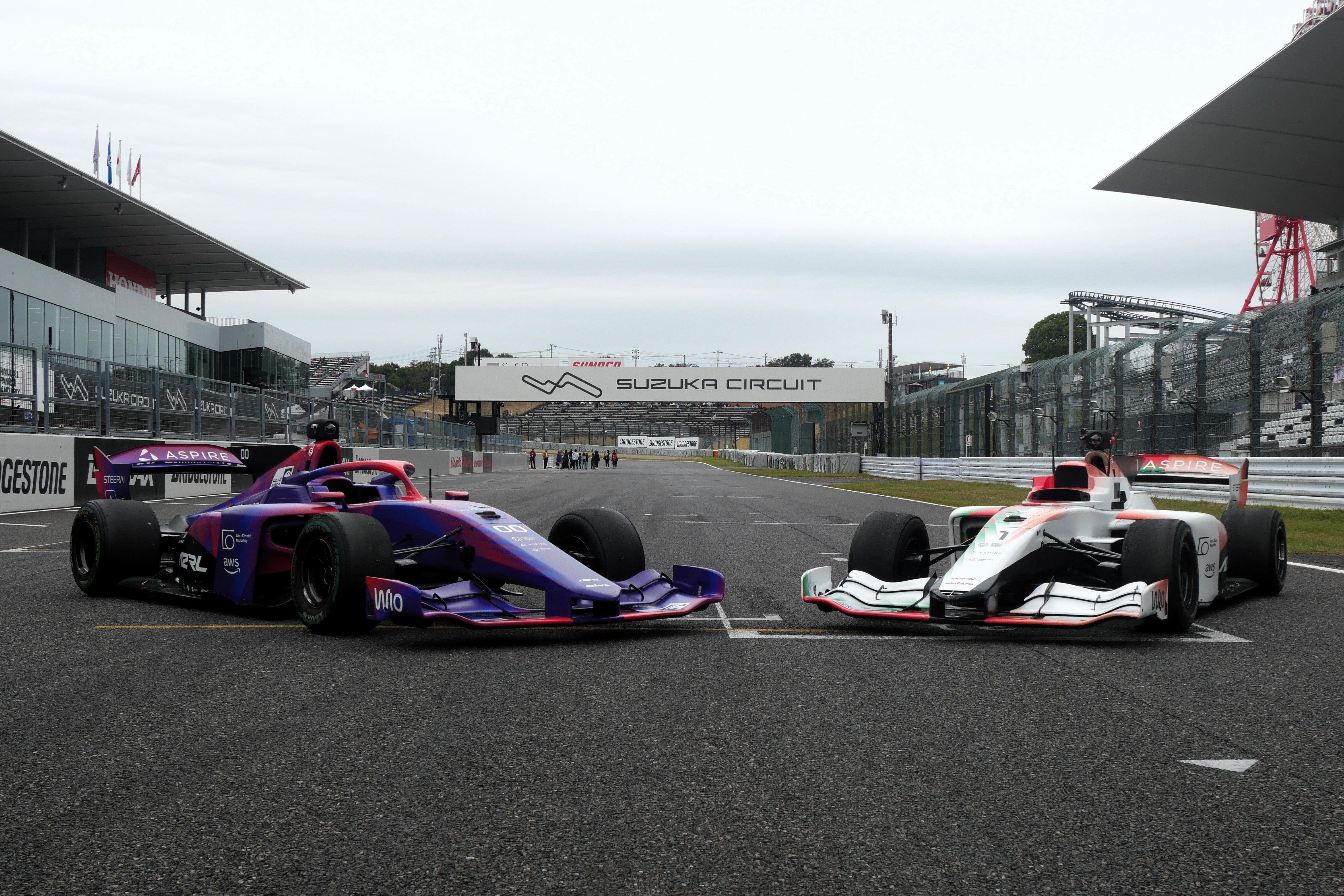 An AI-powered Super Formula SF23 race car (right) lines up alongside a standard Super Formula SF23 car