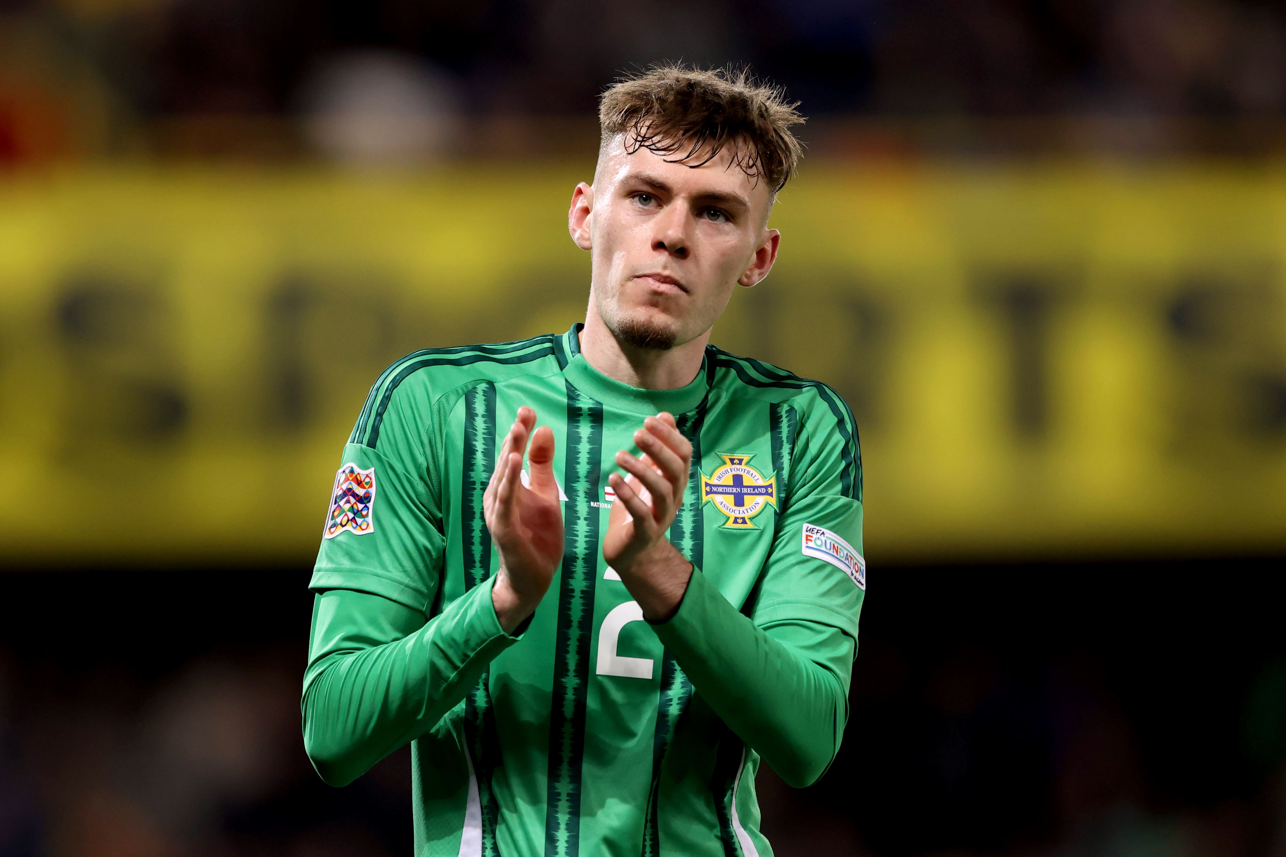 Conor Bradley applauds the Northern Ireland fans (Liam McBurney/PA)