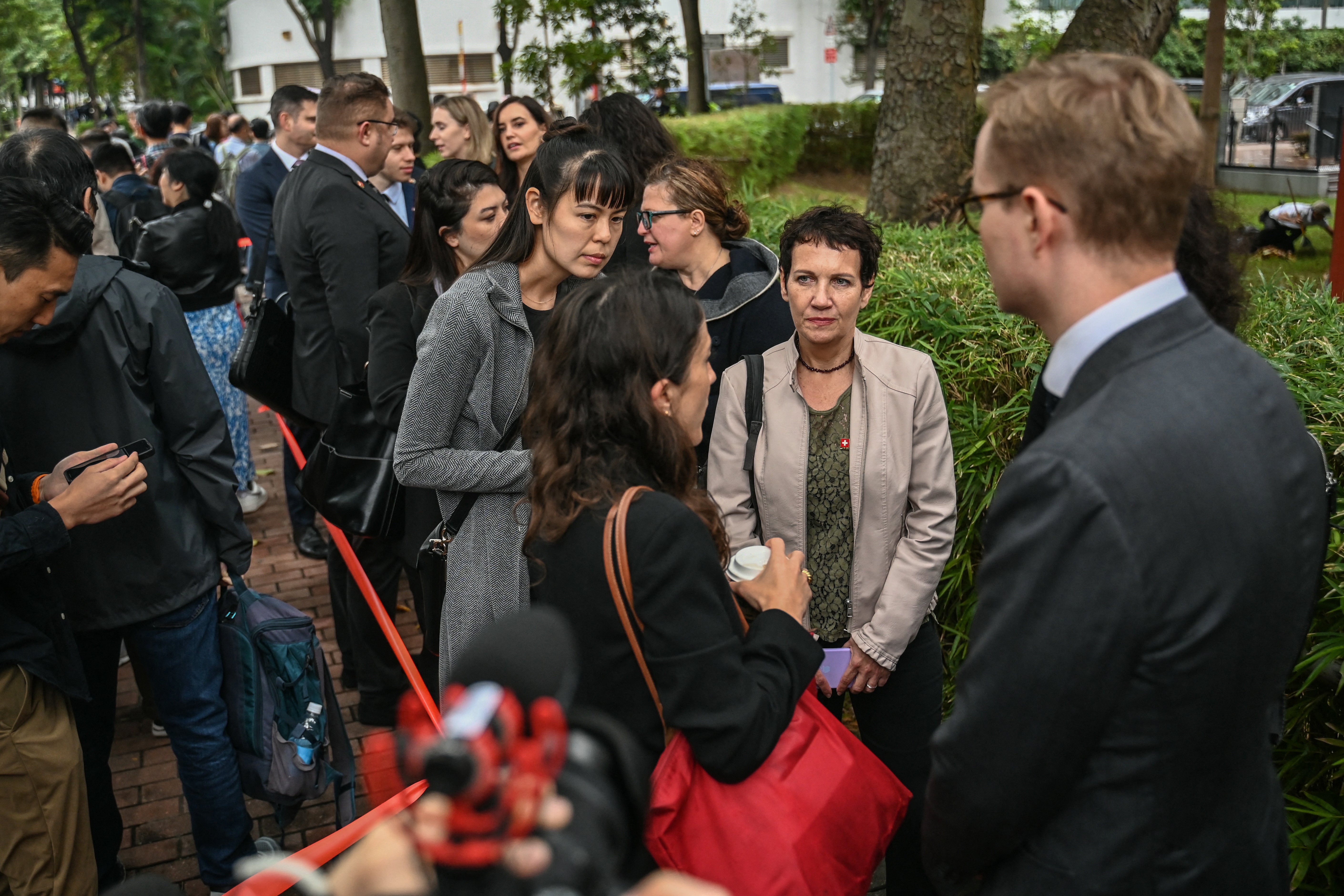 Diplomats queue outside the West Kowloon Magistrates’ Court in Hong Kong on 19 November 2024