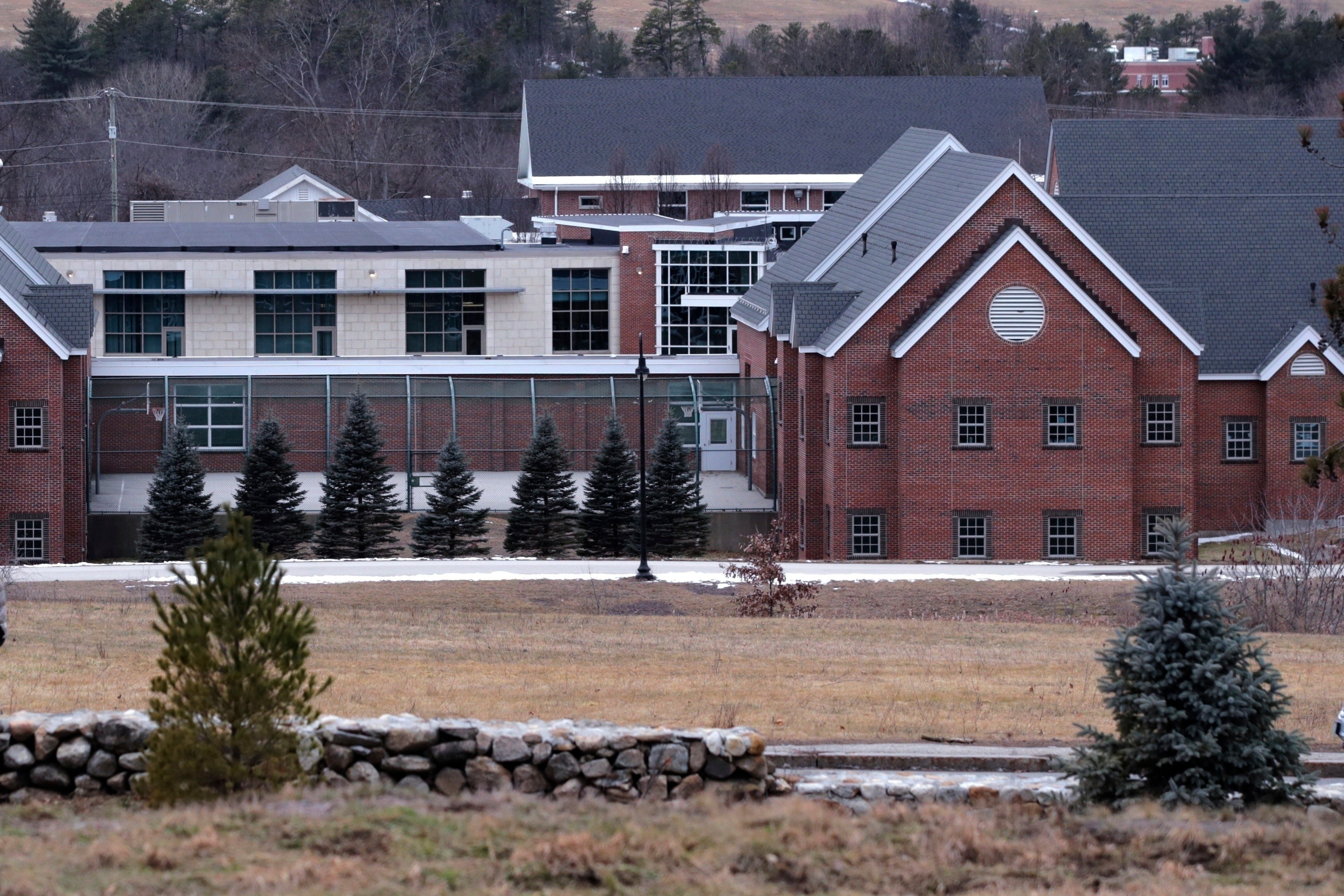 The Sununu Youth Services Center is seen amongst the trees