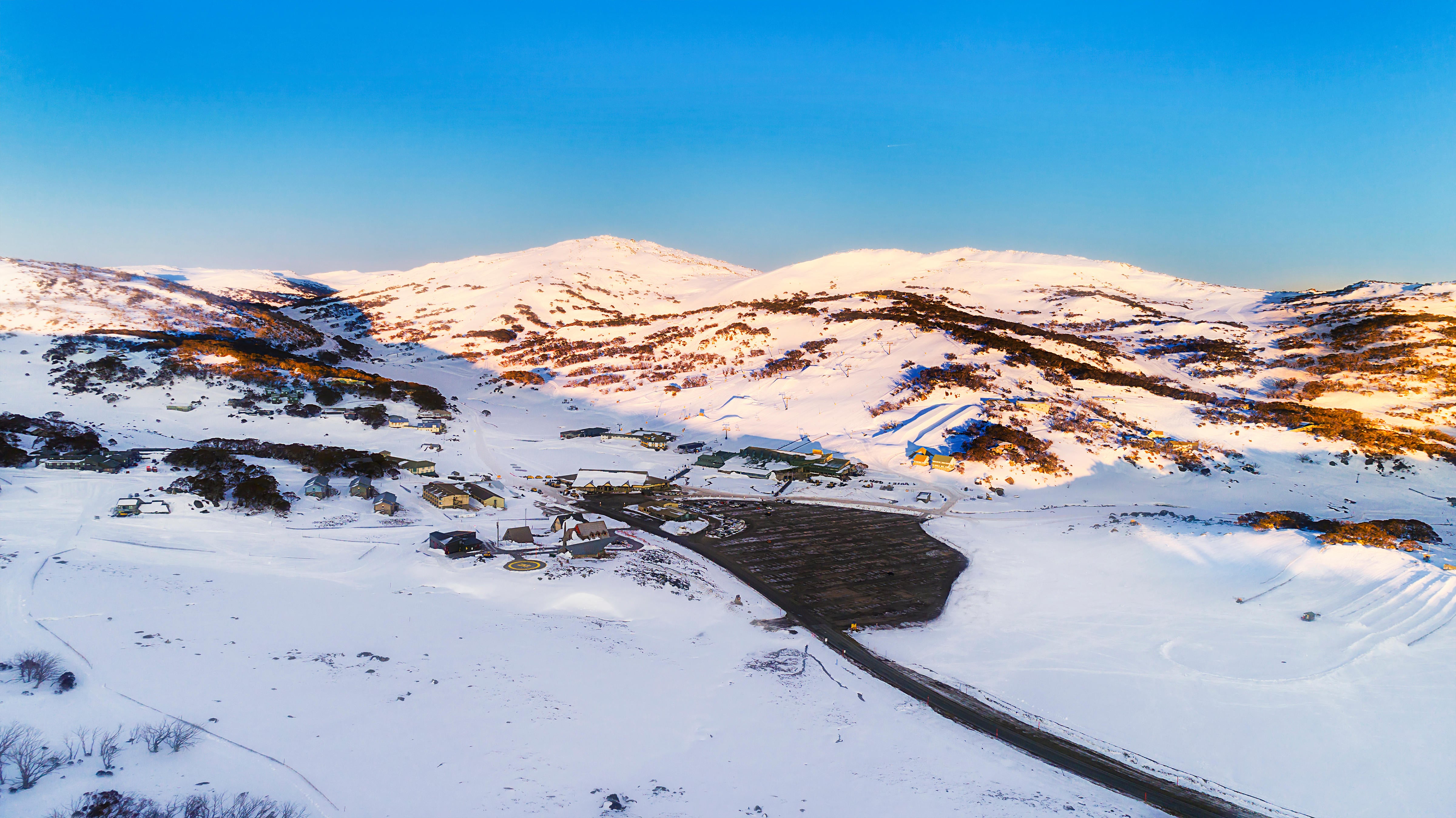 Sunrise over Perisher valley ski resort town in Snowy Mountains of Australia (Alamy/PA)