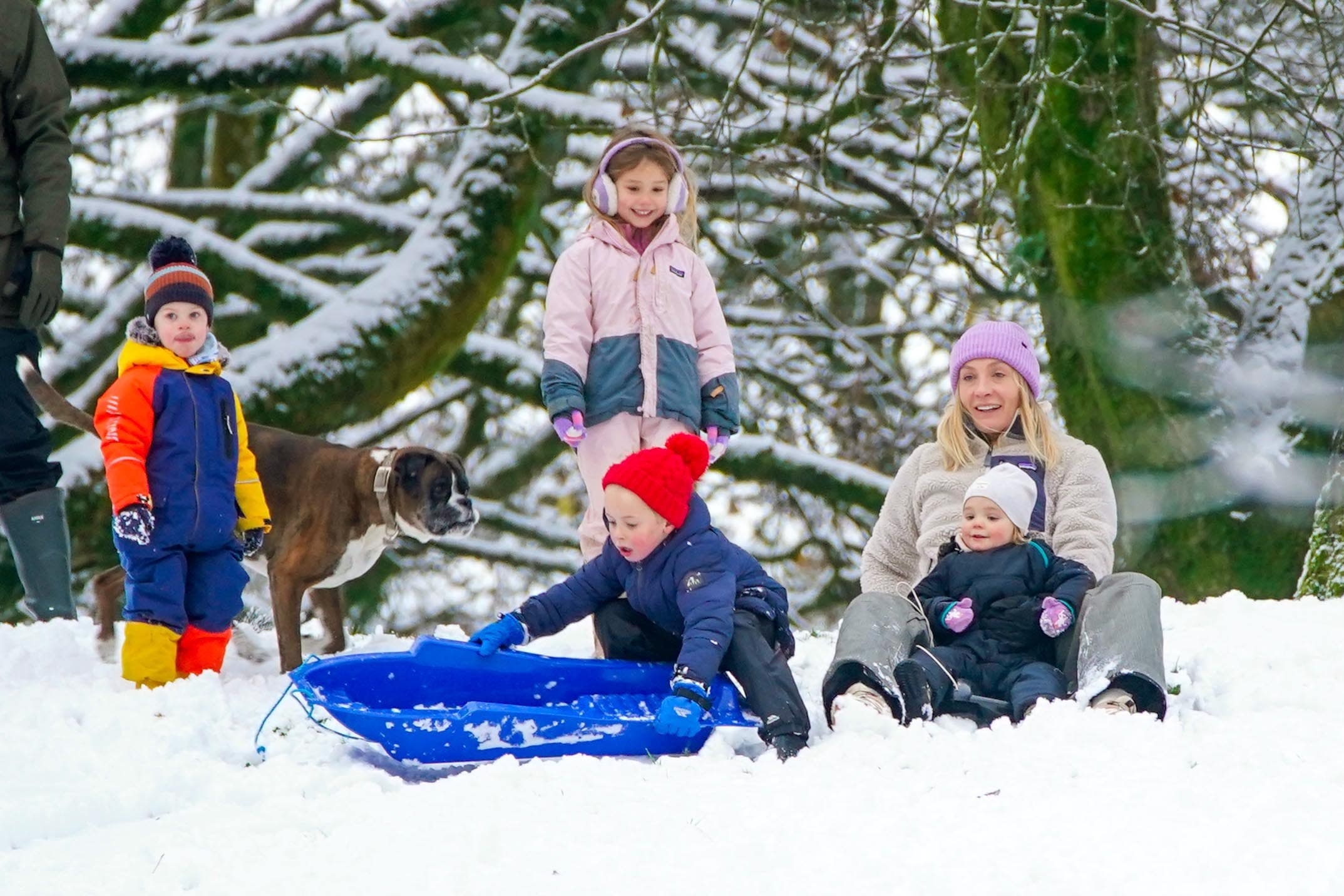 People play in the snow on the hills of Buxton, Derbyshire (Peter Byrne/PA)