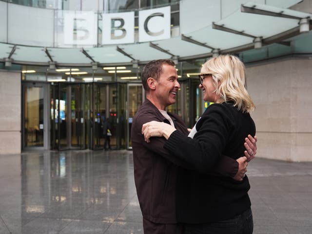 <p>Zoe Ball and Scott Mills embrace outside New Broadcasting House in central London after Ball announced she is stepping down from the Radio 2 Breakfast Show after six years (James Manning/PA)</p>